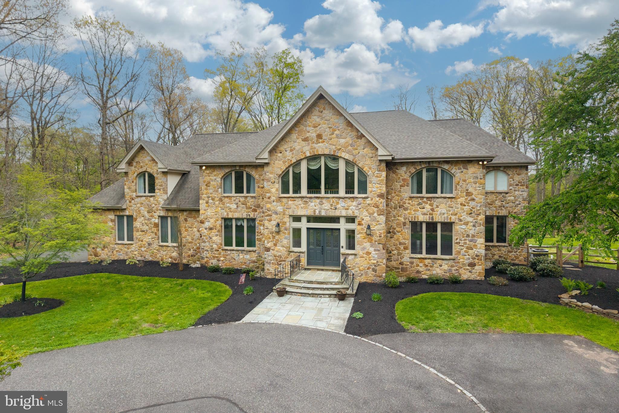 Looking for a tranquil, peaceful setting?  Come take a look at this gorgeous estate home. 6,497 Sq. Ft. Surrounded by 4+ acres, you'll be in your own little world. The double doors lead you to an amazing 2 story foyer. The newer chandelier sparkles & sconce lighting adds to the ambiance. Hardwood floors with perimeter inlay flow through the foyer, dining and living room. Celebrate the holidays in your new formal dining room with butlers pantry. The living room is quite large and could easily accommodate your baby grand piano or create a separate cozy seating area. Need a dedicated home office, with custom built ins for storage? And French doors? Movie nights in the step down family room.  Light the gas fireplace on the chilly nights and snuggle down. The gourmet kitchen and breakfast room is right around the corner. The chef will be quite happy. 5 burner cooktop, Kitchen Aid double ovens and microwave. Custom wall to wall cabinet space for all your kitchen gadgets and platters. Check out the pantry, too! Friends and family can relax at the table or 8' kitchen island. Ample counter and prep space. Beautiful glass tile backsplash with uner cabinet lighting. The sink area opens to the solarium allowing for easy conversation! The 2 story solarium with a wall of windows (some with built in blinds) is spectacular! The newer, covered deck,  adjoins the solarium with French doors. There's about 650 square feet of outdoor entertaining area plus the patio. The recent expansion of the fenced in back yard allows for more space for our furry friends or little ones.  Luxury awaits as you ascend the curved staircase to the impressive landing. Palladium windows and the chandelier make a very impressive showing. The primary bedroom offers 2 walk in closets. The ensuite custom bathroom  is right out of a magazine. Heated tile flooring, separate tiled shower and a wall of cabinetry with 2 sinks give each of you plenty of elbow room. Even the hard days will melt away in this bathtub, situated under a beautiful bank of windows with plantation shutters. Bedroom 2 is a princess (or prince) suite with it's own bathroom. Bedroom 3 is quite large with recessed lighting. There are French doors which open to overlook the solarium below. Bedroom 4 & 5 are quite generous in size. Both with fans and crown molding. They share the updated hall bathroom. There's a great area at the top of the back staircase  providing some storage or even a small play/toy space for the little ones. Head down to the finished basement which does not seem like a basement at all. An additional 2,000+ sq. ft.! Daylight walk out with a window and double doors. A gas fireplace and a recently constructed THEATER! Theater seats, screen and projector included. And a round cushy chair to curl up in for movie night! There's a room for crafts and another for your gym equipment. Plus an updated powder room! Newer heating system and roof in the last few years. Central Vac & speaker system. Souderton Schools. Easy access to shopping and the PA Turnpike.
