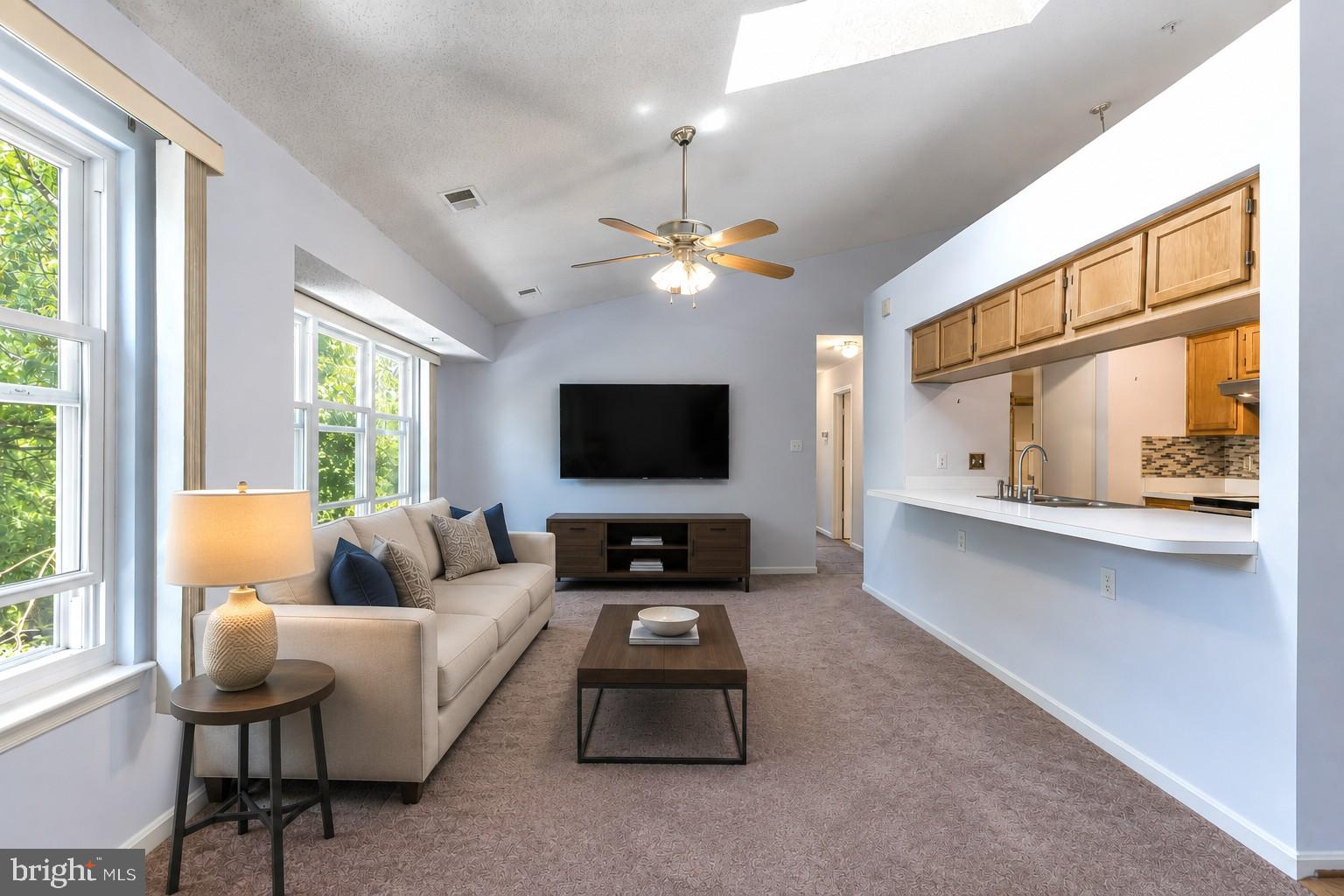 Experience convenient and cozy living in Silver Spring! This classic 2-bedroom, 2-full-bath condo offers an inviting open feel. The spacious floor plan features soaring vaulted ceilings and a large open living room. There's plenty of room to relax and the kitchen features a pass through into the living. In addition to the 2 bedrooms, the home features a separate dining / flex room, perfect for an office, den, studio, or other. This space could easily be a third bedroom. The roof is NEW in 2026! Windows replaced in 2020 and new skylight in 2026.

Cook up a feast in the updated kitchen that boasts ample counter space and modern appliances. New windows enhance energy efficiency and natural light throughout the home. A full-size in-unit washer and dryer provide added convenience. And storage is abundant with a walk-in primary closet, coat closet, and storage in the laundry center. 

Enjoy ample parking for residents and guests, along with a location that places you just steps from community amenities including tot lots and swimming pools. Easy access to shopping, dining, commuter routes, and everyday conveniences mean this one won't last long! See it today.
