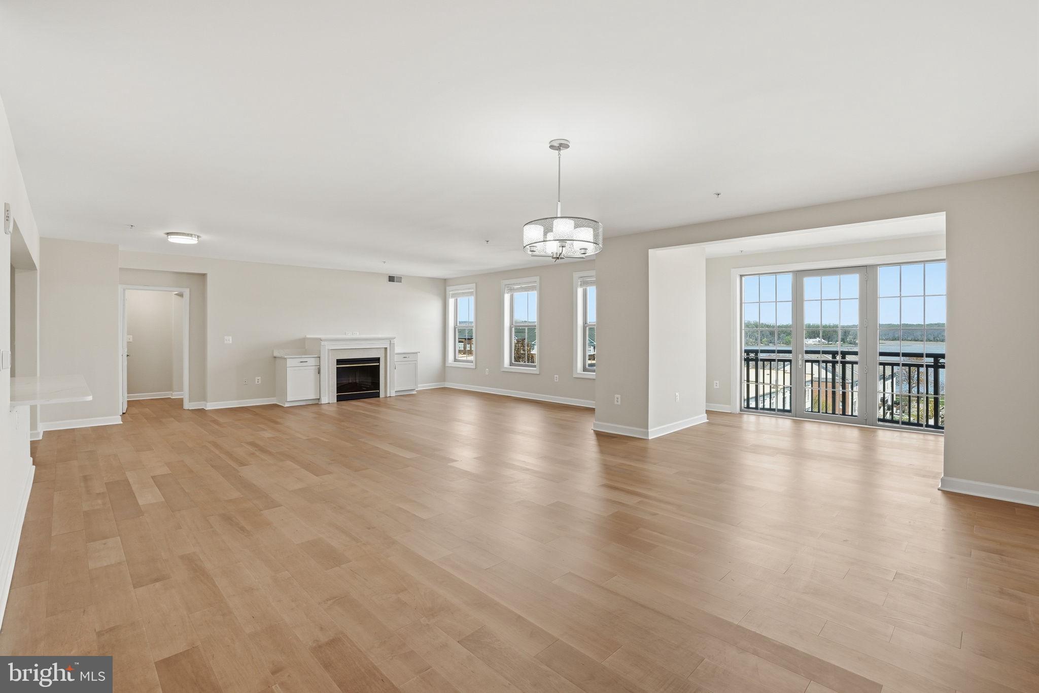 Welcome home to 485 Harbor Side St Unit 604 located in Belmont Bay with views of the water!  This 2 bedroom, 2 bathroom Condo offers 2500 square feet.  It is located on the 6th floor of an Elevator building and has Garage parking for one car.  The unit was fully remodeled in 2023 to include LVP flooring throughout - you will need to use area rugs in 75% of the space.  New AC in 2024. Other updates include paint, new slow closing cabinets, modern quartz counters and stainless steel appliances including a built-in microwave, an induction oven, dishwasher and French Door refrigerator with water and ice dispenser.  The open floor plan includes a Bonus Room that can double as a home Office.  There is a Sitting Area off the Dining Area that opens to a Juliet Style  Balcony. In the Living Room there is an electric fireplace with new built-in cabinets.  The front facing bedrooms are on opposite ends of the unit and the Primary Suite features two walk-in closets and an enormous attached Bathroom that includes a shower with glass surround and a jetted soak tub as well as two separate vanities.  The second Bedroom has a good size closet and great views. Full, hall, bathroom features an updated vanity and shower/tub with tile surround.  Updated Laundry Room includes a new Washer and Dryer plus shelving and cabinetry. Building amenities include a Pool, Fitness Center, Club Room and Tennis Courts. Condo is located within the Belmont Bay HOA. VRE - Commuter Rail is just before the entrance to the community. Location is tucked away yet offers easy access to major commuter routes.