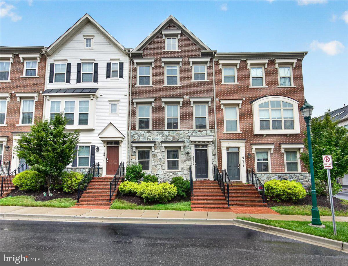 Welcome to 13069 Martz Street, a beautifully designed Craftmark Homes Annapolis model offering four levels of spacious living, approximately 2,400 square feet, 3 bedrooms, 3 full baths, 2 half baths, and a 2-car garage. 

With its attractive brick and stone front, this townhome delivers the space and feel of a single-family home while offering the ease of low-maintenance living. Located in sought-after Clarksburg Town Center, this is a unique opportunity to own one of the community’s most desirable layouts, where resort-style amenities and everyday convenience come together beautifully.

The entry level welcomes you with a spacious recreation room, a convenient powder room, utility closet, and access to the two-car garage. The private driveway offers parking for two additional cars.  Upstairs, the main level features a bright and open floor plan with generous living and dining areas, a gourmet kitchen with stainless steel appliances, quartz countertops, a pantry, and a large center island perfect for gathering, entertaining, and everyday living. Step outside to the spacious deck, ideal for relaxing or enjoying a quiet evening.

The bedroom level offers two impressively sized bedrooms, including a stunning primary suite with a large walk-in closet and private ensuite bath. Each bedroom features its own walk-in closet and ensuite bathroom, creating comfort and privacy throughout. The top-level loft offers incredible flexibility and can serve as an additional bedroom, home office, gym, media room, or second living space. Ample storage throughout the home adds to the thoughtful and functional design.

Located in amenity-rich Clarksburg Town Center, residents enjoy bike paths, community green spaces, outdoor concerts at the dedicated amphitheater, a fabulous community pool, and easy access to shopping, dining, commuter routes, and everyday conveniences. Enjoy the room and comfort of a single-family home without the added care, all in a vibrant, resort-style community conveniently located near everything. Don’t miss this special opportunity. Schedule your showing today!