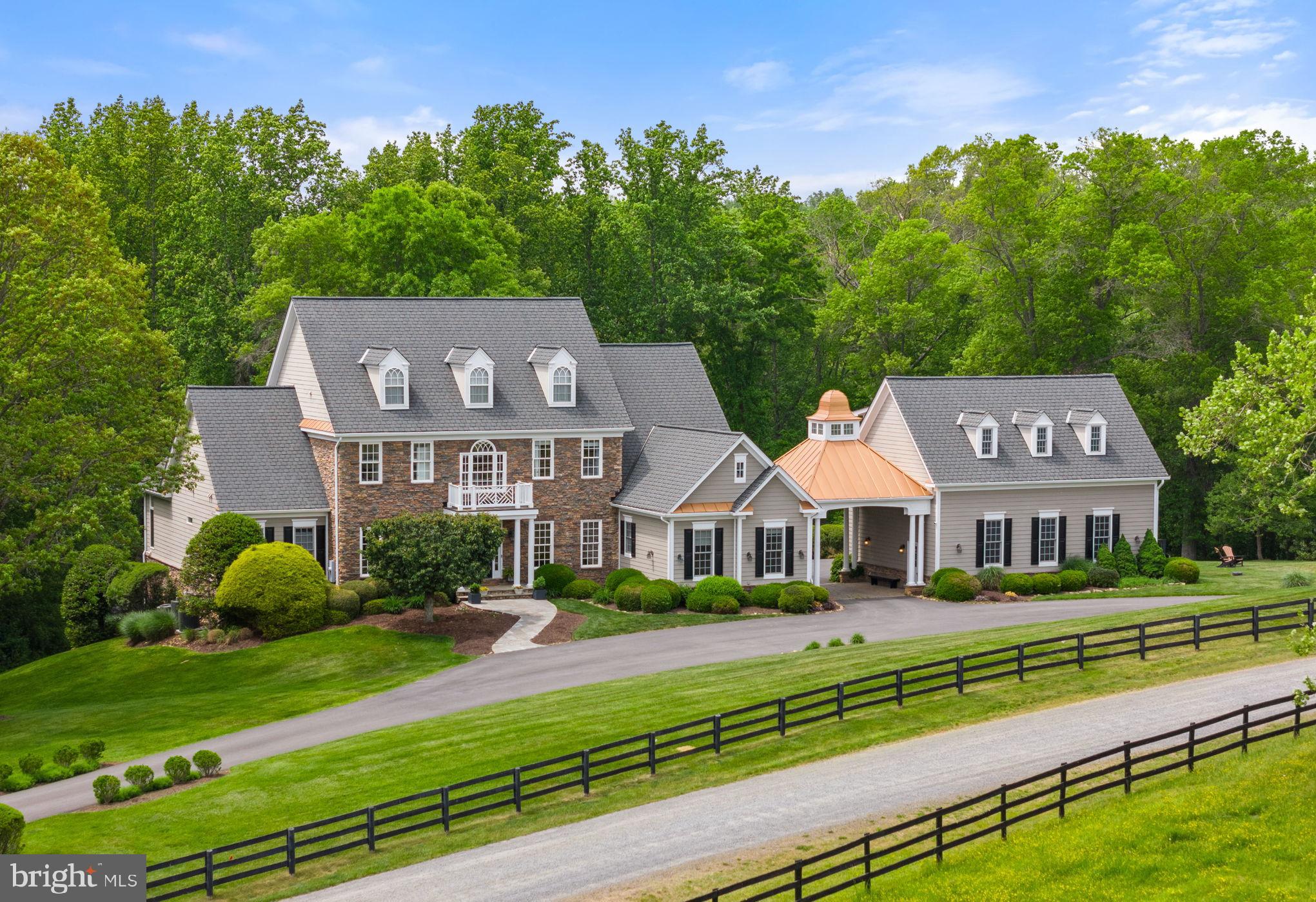 Nestled on over 7 acres overlooking the Little River, "Eden Glen" stands as a testament to meticulous craftsmanship and timeless elegance. Situated within a secluded enclave of five custom-built residences along Light Horse Court and just east of the town of Middleburg, this extraordinary property offers a sanctuary of natural beauty and refined living. The setting is serene, offering a private retreat from the bustle of everyday life while still providing easy access to Dulles International Airport and downtown Washington. "Eden Glen" has been lovingly maintained and thoughtfully updated by its current owners, who have preserved its essence while enhancing its allure. Gleaming Brazilian cherry floors, high-end granite countertops, and commercial-grade appliances are just a few of the luxurious upgrades that adorn this exceptional residence. Step inside to discover traditional yet comfortable living spaces designed for both relaxation and entertainment. The main level features a gracious living room, formal dining room, and a gourmet kitchen that seamlessly flows into the inviting family room. A wood-paneled library provides a quiet retreat for work or study. The primary bedroom suite, located on the main level, is a haven of tranquility with its additional sitting room and lavish ensuite bath, complete with a steam shower, soaking tub, and spacious walk-in closets. Upstairs, three guest bedroom suites offer comfort and privacy, one boasting its own ensuite full bath. The fully finished walk-out lower level is where a world of entertainment awaits. A recreation room with a bar, glass wine cellar, a dedicated movie room, an exercise room, and ample storage space provide endless possibilities for leisure and relaxation. Outdoor living takes center stage at "Eden Glen," with a multitude of spaces designed for enjoyment and relaxation. A walk-out deck on the main level offers an open seating area, while the lower-level terrace features an outdoor kitchen, seating area around a unique stone chimney, and a hot tub, perfect for gathering with loved ones. A meandering stone walkway leads to a one-of-a-kind pool complex, nestled just below the house. The heated pool features five built-in sitting benches and a tanning ledge, surrounded by extensive stone decking and lush landscaping illuminated by specially designed lights. Connected to the main residence via a porte cochere is the Carriage House, boasting a three-car garage and flexible space above, ideal for a studio, home office or guest quarters. If you're seeking a retreat in the heart of hunt country with access to miles of walking trails, "Eden Glen" offers unparalleled luxury and serenity. Don't miss the opportunity to make this extraordinary estate your own. Starlink internet conveys. Schedule your private tour today and experience the epitome of country living. Be sure to watch the video!