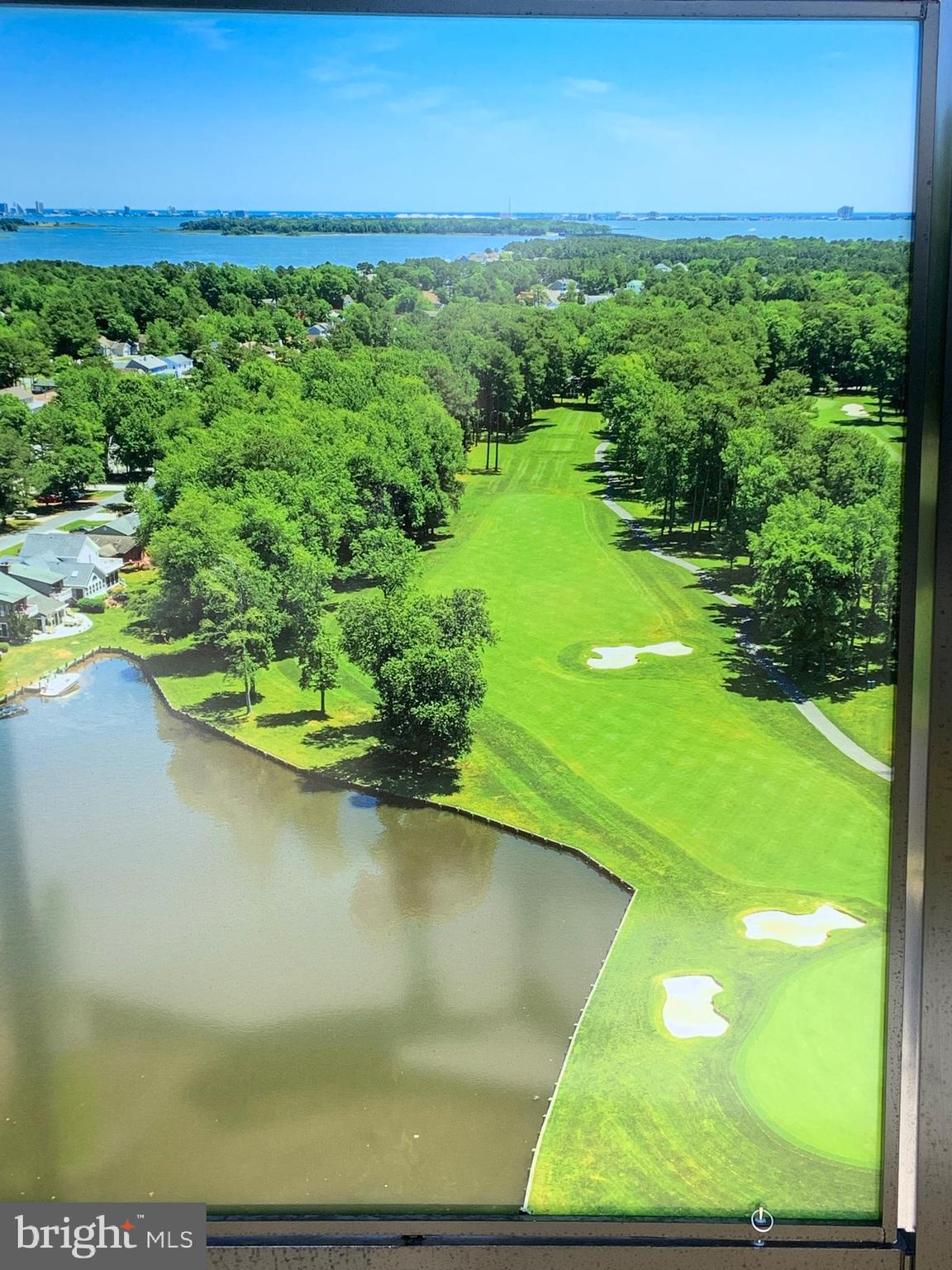 What a view looking straight down the 3rd fairway of the Ocean Pines golf course!  Walk to the golf club to start your tee time or grab a bite to eat!  One level living with a single car garage, rear deck and a fantastic Sun Room with its own mini-split heat pump.  The 12x4 entry foyer welcomes you to the open living plan featuring luxury vinyl plank flooring and two sets of sliding glass doors to the rear.   Stainless Steel appliances, including a cooktop and wall oven, large breakfast bar, tiled backsplash and double pantry complete the fully functional kitchen.  There's lots of room in the 13x15 primary suite, containing  a ceramic tiled bath floor and a 4 foot shower.  A front loading washer and dryer is located within the guest bathroom, which has a tub/shower.   All located within the award winning Ocean Pines community, just a short drive from the beaches of Ocean City and Assateague Island National Seashore!