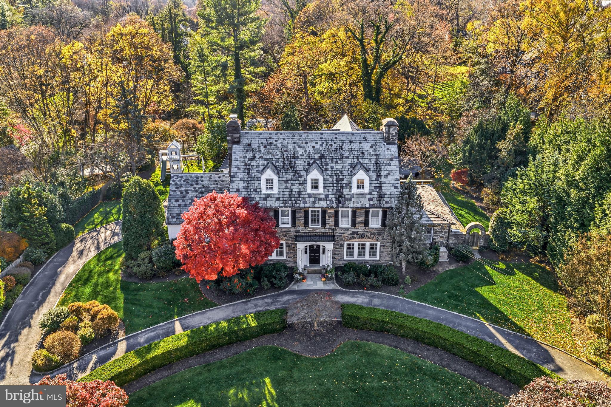 Welcome to this simply spectacular, stone Main Line residence with pool and pool house,  majestically set on a private, breathtakingly landscaped lot in the highly coveted, walkable "Merion Cricket" neighborhood, in prestigious North-side Haverford. Rarely does a property like this become available, within a short walking distance to trains, clubs, renowned public and private schools, endless shopping, fabulous restaurants and more. Beautifully renovated and updated throughout, this sun-filled, gracious center hall home offers generously proportioned, bright rooms with an easy open flow, original restored floors, millwork, moldings and 1920's architectural details, perfect for comfortable everyday living and effortless entertaining on an intimate or larger scale. Endless features include an inviting living room with fireplace, spacious dining room, expansive sunroom/ office with wet bar and wine refrigerator, newly renovated white gourmet kitchen with custom cabinetry, natural marble countertops and Thermador chef's appliances opening up to a sunny breakfast room with French doors, family room with fireplace, exterior terraces with serene views, convenient mudroom and rear staircase leading up to the second floor. The  original grand staircase flows openly from the foyer to 2nd and 3rd floor landings. Upper level amenities include a 2nd floor luxurious primary suite with expansive walk-in closet/ dressing room, timeless tumbled marble bathroom, two vanities an oversized frameless glass shower and radiant heated floors, 3 additional second floor bedrooms with 2 additional updated full neutral-tiled baths, new second floor laundry, third floor with a 5th bedroom  with en-suite renovated bathroom, two additional large, bright bedrooms or potential office spaces and an updated full hall bathroom. The walk-up lower level offers a finished game room with wet bar, stone fireplace, large second laundry room, lots of dry storage and easy access to the 3 garage spaces and rear grounds. The stunning pool, colorful perennial gardens, extensive hardscaping, charming pool house with changing room and full bathroom complete this incredible property! Further recent updates include electrical upgrades, new generator, new water heater and more. This package offers rare walkable access to trains, clubs, fabulous shopping, restaurants, renowned schools and more. Move right in!