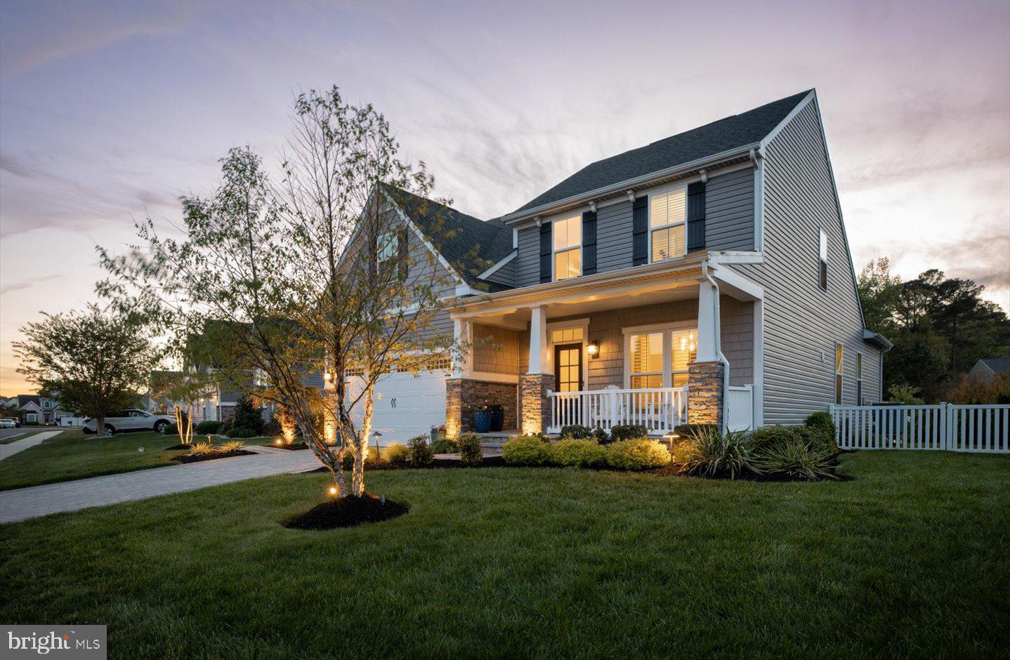 Superb Location just 2.2 short miles from downtown Rehoboth Beach’s beautiful shoreline, boutique shops, and renowned dining.  Tucked just off the scenic Breakwater Junction Bike Trail, East of Route 1, this home invites a lifestyle of morning rides, sunset strolls, and effortless access to everything coastal living has to offer. Within steps, you’ll enjoy the community’s resort-style amenities—pools, athletic courts, a fitness center, and picturesque sidewalks—all while lawn maintenance is handled for you, giving you more time to relax and enjoy. The owner’s passion for outdoor living is unmistakable. A private paver driveway welcomes you home, leading to a charming front porch that overlooks a beautifully landscaped yard—perfect for morning coffee or quiet evenings. Out back, your personal retreat awaits: an expanded paver patio with pergola creates the ideal setting for grilling, entertaining, or simply unwinding in nature. Surrounded by fencing and lush plantings, this space offers both beauty and privacy. The screened porch, complete with an EZ Breeze window system, allows you to savor fresh coastal air across multiple seasons in comfort. Inside, the home radiates warmth and character. Thoughtful details like hardwood floors, shiplap accents, vaulted ceilings, and a cozy gas fireplace create an inviting atmosphere, while the sunroom fills the space with natural light—perfect for reading, relaxing, or gathering with loved ones. Plantation shutters throughout add timeless coastal elegance. The kitchen is as functional as it is stylish, featuring upgraded appliances including, Dacor dual power range (electric oven and gas cooking), Bertazzoni French door refrigerator/freezer, and whisper quiet Bosch dishwasher, sleek quartz countertops, and a classic, timeless backsplash. Whether you’re enjoying casual meals at the breakfast bar or hosting memorable dinners in the spacious eat-in area, this space is designed to bring people together. The first-floor primary suite offers everyday convenience and a peaceful retreat, complete with a custom walk-in closet and a spacious en-suite bath including a linen closet, walk tiled shower and dual vanity. Upstairs, a generously sized second primary suite provides comfort and privacy for guests or family, along with two additional bedrooms and a hall bath. A versatile loft area offers the perfect flex space—ideal for a home office, homework zone, or cozy lounge. The finished basement adds incredible value and versatility, featuring newly installed LVP flooring for a fresh, modern feel. With a full bathroom and space that can easily be converted into a fifth bedroom, it’s perfect for guests or extended living. Two large unfinished areas ensure storage is never a concern, with one currently serving as a home gym. This is more than just a home, it’s a lifestyle. From peaceful mornings on the porch to active days on the trail and evenings spent entertaining under the pergola, every detail has been designed to help you live your best coastal life.