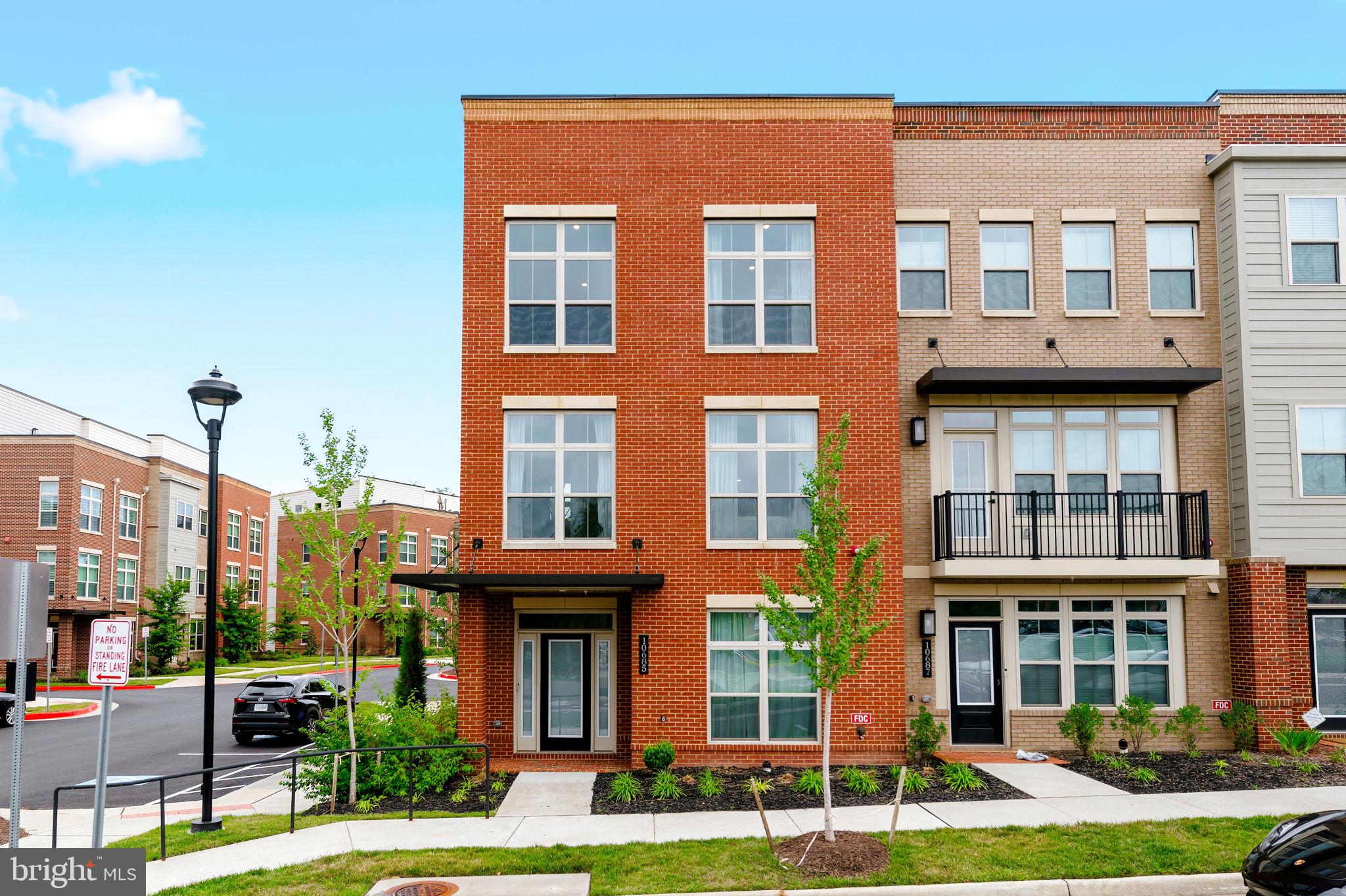 Introducing 10685 Fairgrounds Dr a newly built townhome that doesn't just meet the bar for modern Fairfax living, it resets it.  This is, without question, the best floorplan in the community.   Spacious, light-filled, and configured with real intention for modern, everyday living.  Step inside and the level of custom designer finish is immediately clear.  A statement chandelier and bespoke curtains set the tone in the dining space, where dramatic tone on tone walls and gallery style millwork create a moody, editorial backdrop rarely found in new construction.  The kitchen is nothing short of a showpiece, a fully upgraded, bespoke design anchored by a waterfall edge island, high end cabinetry, and finishes that feel more custom home than townhome.  Three bedrooms and four bathrooms (2 full, 2 half) give this floorplan room to breathe, and every inch has been maintained in absolutely pristine, like new condition.  A private deck extends the living space outdoors, perfect for entertaining or unwinding after a long day.  Location seals the deal in the highly sought after Paul VI mixed-use development within walking distance of three community tot lot playgrounds and a baseball field at Pat Rodio Park, steps from daycare options, and surrounded by some of Fairfax's most popular restaurants. The HOA delivers true worry free living, covering trash service, snow removal, and common area maintenance.  Located within Fairfax High School, Katherine Johnson Middle, and Providence Elementary in Fairfax County Public Schools.  This is a rare opportunity to own a home where the design work is already done, all that's left is to move in.