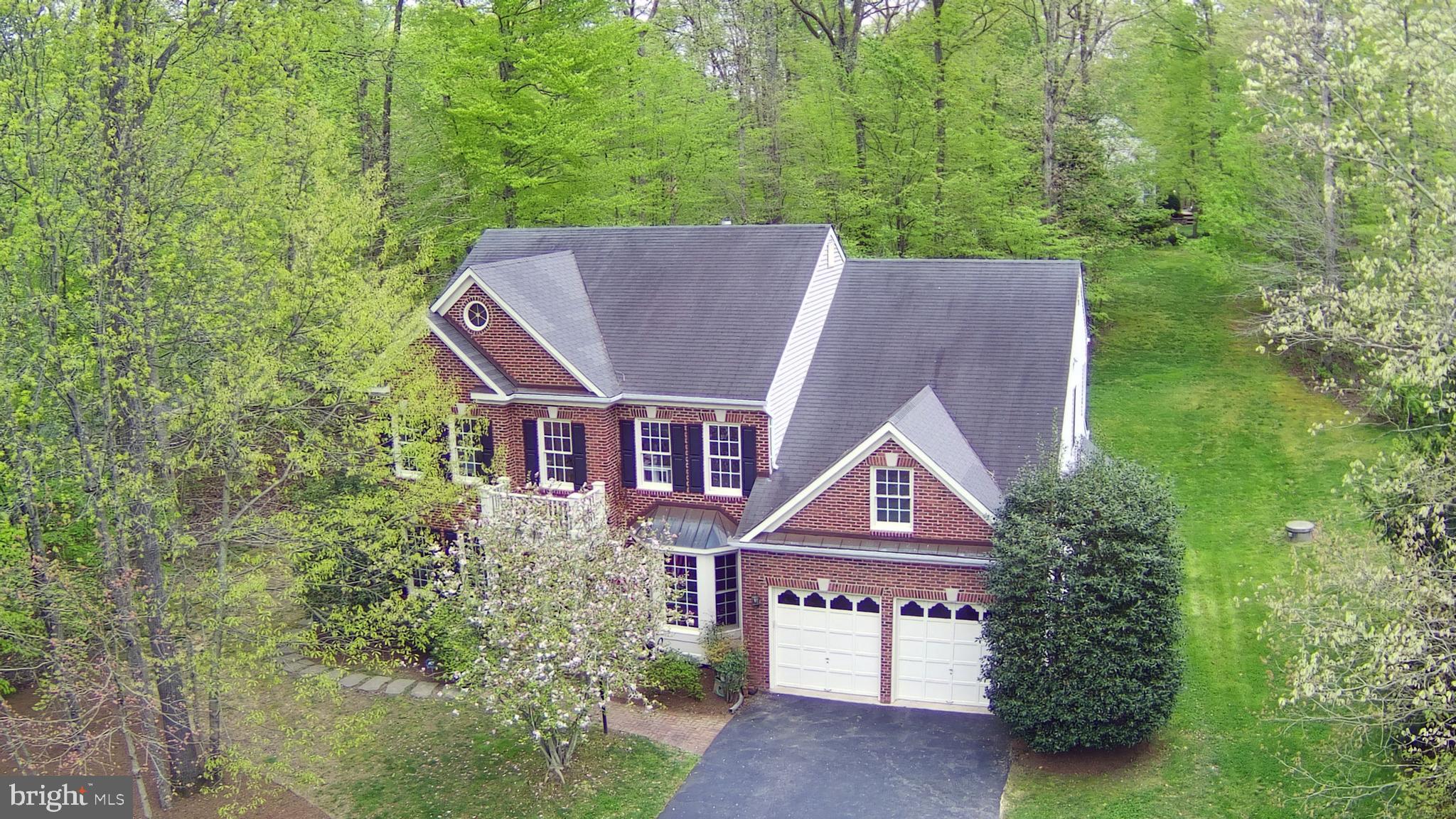 Don’t miss  out on this gorgeous well maintained brick front colonial in Holly Forest. The main level welcomes you with a 2-story foyer, crown molding, office/study and formal living/dining rooms with bamboo floors and bay window. The updated gourmet kitchen has plenty of recessed lighting, ceramic floors, granite and Corian counters, center island, double ovens, gas cooktop, pantry and eat in area with walkout to the screened in deck.  There is a main level laundry and mud room.  The extended family room has a gas fireplace and is wonderful for relaxing after a long day. Upstairs you will find an expansive master bedroom suite with sitting area and enormous walk-in closet. The light filled luxury master bath has a soaking tub and separate shower. Additionally, there are 3 additional bedrooms, 2 with attached Jack and Jill bath and additional hall bath upstairs.  Head downstairs to the finished basement where you will find a rec room with gas fireplace for additional entertaining, possible theater room/craft room, full bath, and walkout to the paver stone patio and wooded backyard with shed. Zoned for Colgan HS and Benton MS.
