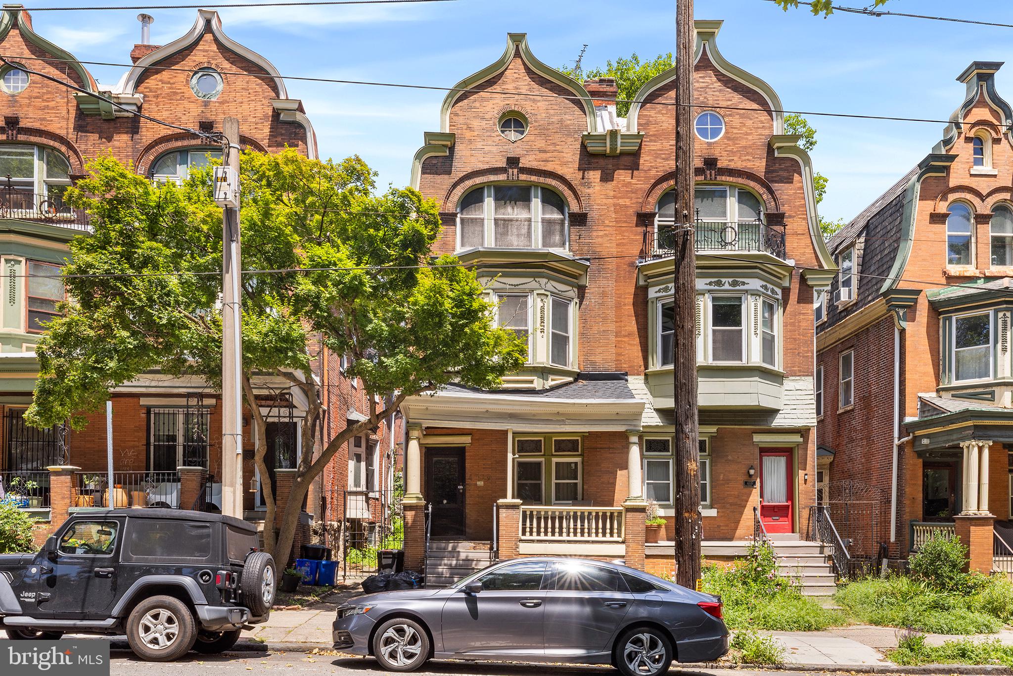 A rare opportunity to own a piece of West Philadelphia history, directly across from the iconic Clark Park. Built in 1901, this distinguished six-bedroom, two-bath residence showcases the craftsmanship and architectural character that define the neighborhood's most admired historic homes.

From the moment you enter, you're welcomed by remarkable original woodwork, intricate millwork, beautifully preserved parquet hardwood floors, original stained glass, decorative fireplaces, and a grand staircase that serves as the home's centerpiece. Soaring ceilings and generously proportioned rooms create an inviting atmosphere while honoring the home's rich architectural heritage.

Offering six spacious bedrooms and two full bathrooms, this home provides exceptional flexibility for a growing household, multi-generational living, or a dedicated home office and creative spaces. Formal living and dining rooms are ideal for entertaining, while the expansive eat-in kitchen offers abundant cabinetry, workspace, and everyday functionality.

Step outside to enjoy a welcoming front porch overlooking Clark Park or retreat to the private rear brick patio, creating the perfect setting for outdoor dining, gardening, or relaxing.

The location is truly exceptional. Situated directly across from Clark Park, you'll enjoy one of Philadelphia's premier neighborhood parks, home to the renowned Shakespeare in Clark Park performances, farmers markets, and year-round community events. Baltimore Avenue's celebrated Dollar Stroll, seasonal festivals, neighborhood cafés, restaurants, and University City District programming are all just outside your door. Convenient SEPTA trolley service provides direct access to University City and Center City, while the campuses of the University of Pennsylvania, Drexel University, and Saint Joseph's University are all just minutes away.

Homes of this caliber are increasingly rare. Rich in original craftsmanship, timeless architectural details, and set in one of Philadelphia's most vibrant and historic neighborhoods, 4339 Baltimore Avenue is ready for its next chapter.