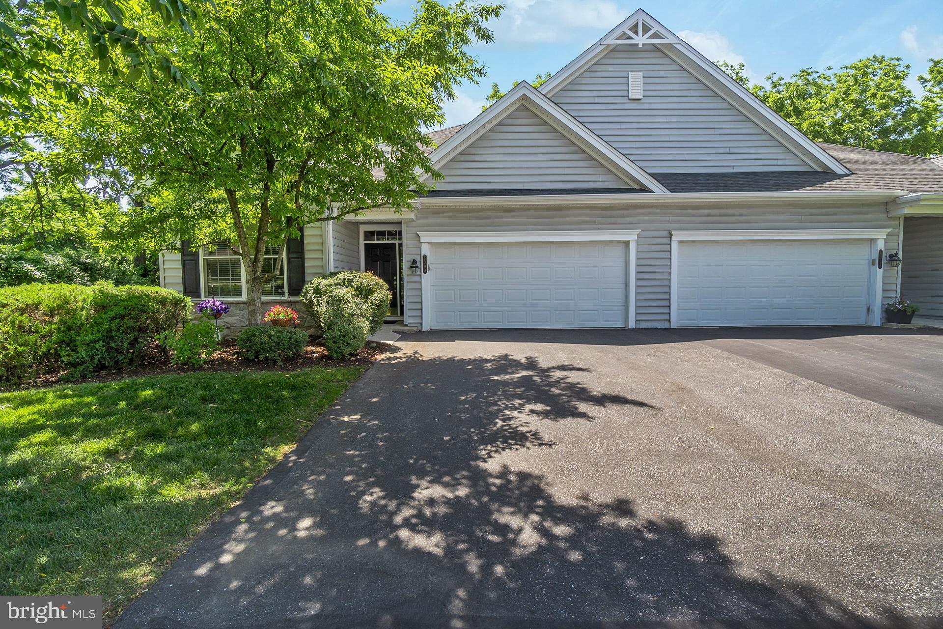 Welcome to easy living in the highly sought-after Traditions of America at Hanover, an award-winning 55+ active adult community designed for a vibrant, low-maintenance lifestyle. Enjoy the convenience of having all outdoor maintenance taken care of for you, giving you more time to take advantage of the community's exceptional resort-style amenities.

This beautifully maintained, original-owner 2-bedroom, 2-full-bath condo is perfectly positioned on a spacious lot with a private, tree-lined backdrop, creating a peaceful setting to relax and unwind. Inside, you'll find an inviting open-concept layout highlighted by soaring vaulted and architectural ceilings in the living room, filling the space with natural light and a sense of openness. Elegant tray ceilings in both the entryway and primary bedroom add an extra touch of sophistication.

The well-appointed kitchen features granite countertops, ample cabinetry, and a functional layout ideal for everyday living and entertaining. The spacious primary suite offers comfort and privacy, while the second bedroom and full bath provide flexibility for guests, hobbies, or a home office.

Step outside to the rear deck and patio, where you can enjoy your morning coffee or evening relaxation while taking in the tranquil wooded views. Additional features include efficient gas heat, central air conditioning, and pride of ownership throughout.

Residents enjoy access to outstanding community amenities, including a vibrant clubhouse, heated outdoor pool, spa, fitness center, tennis and pickleball courts, and a variety of social activities and events that make it easy to stay active and connected.

Move in with confidence—the sellers will provide a clear Certificate of Occupancy for the home.

Experience the carefree lifestyle you've been waiting for in one of the area's premier active adult communities!