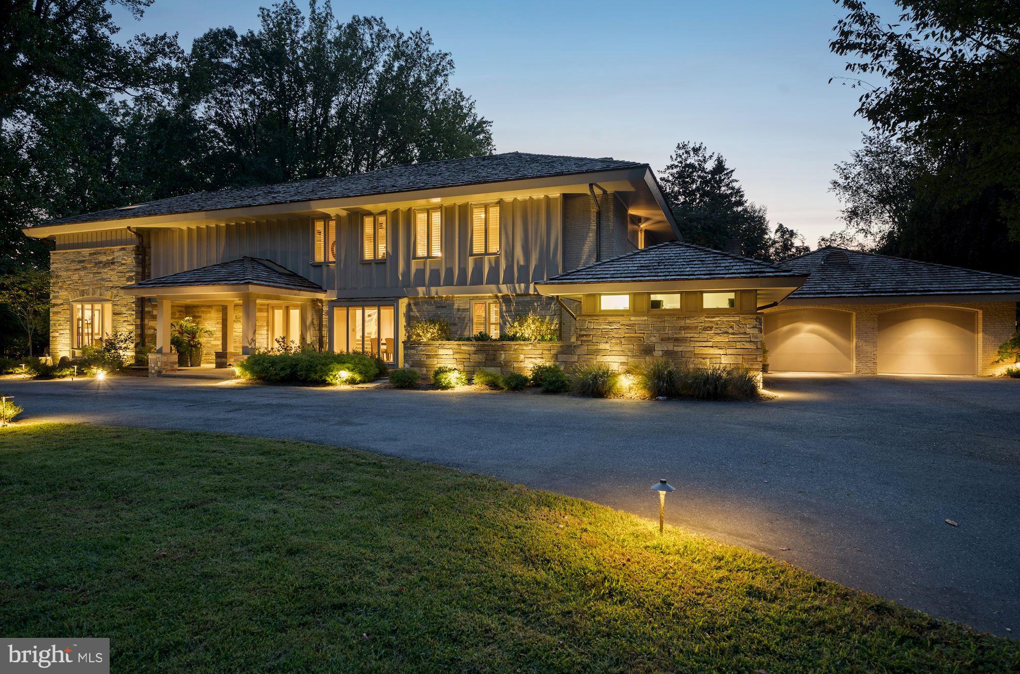 This luxurious custom contemporary home has been renovated to perfection and has two additional buildings on its manicured acre-plus grounds. A guest house, pool, pool house, stone patio, outdoor kitchen and lovely gardens complement the sparkling 7,000 square foot residence.  Carefully upgraded and appointed by its designer-owner, this is a dream home for indoor and outdoor entertaining and living in total comfort. A large circular driveway and portico welcome guests to the home. Outstanding features include an easy flow, lofty ceilings, fine wood floors, large windows offering views of trees and greenery, large walls accented with fine art work, fine trim work and designer fixtures. Three fully finished levels offer six Bedrooms all with ensuite baths, six Full Baths, and two Half Baths. The gorgeous Dining Room accommodates large-scale dining. The renovated Kitchen is a delight with plentiful white cabinetry, upscale stainless steel appliances and backsplash, and designer lighting.  A service entry from the two-car garage leads to the Kitchen via a service area with closets and an extra-large laundry room.  A main level Office with built-ins can serve as a den or guest bedroom, with ensuite bath. The large Breakfast Room opens to the patio through glass doors. A Family Room with stone fireplace and bar has patio access. The spacious Owner's Suite has a Sitting Room and Bedroom opening to a large terrace, a luxurious Owner's Bath and an exceptional walk-in closet. There are three additional large Bedrooms on the upper level, with walk-in closets and ensuite Baths. The fully finished lower level provides a luxurious world of its own, with Guest Bedroom, luxury Bath with sauna, fully equipped Media Room, large Family Room, Exercise Room and large storage areas. Outdoors, the built-in grill area makes outdoor entertaining a breeze. The guest house offers an additional Bedroom, Full Bath, Kitchenette and sauna. The pool house offers a large screened porch with bubbling hot tub. The grounds offer a quiet retreat with room to entertain, dine, relax, swim and enjoy the outdoors in perfect privacy. Every inch of this property displays the owners' extensive improvements and impeccable taste.