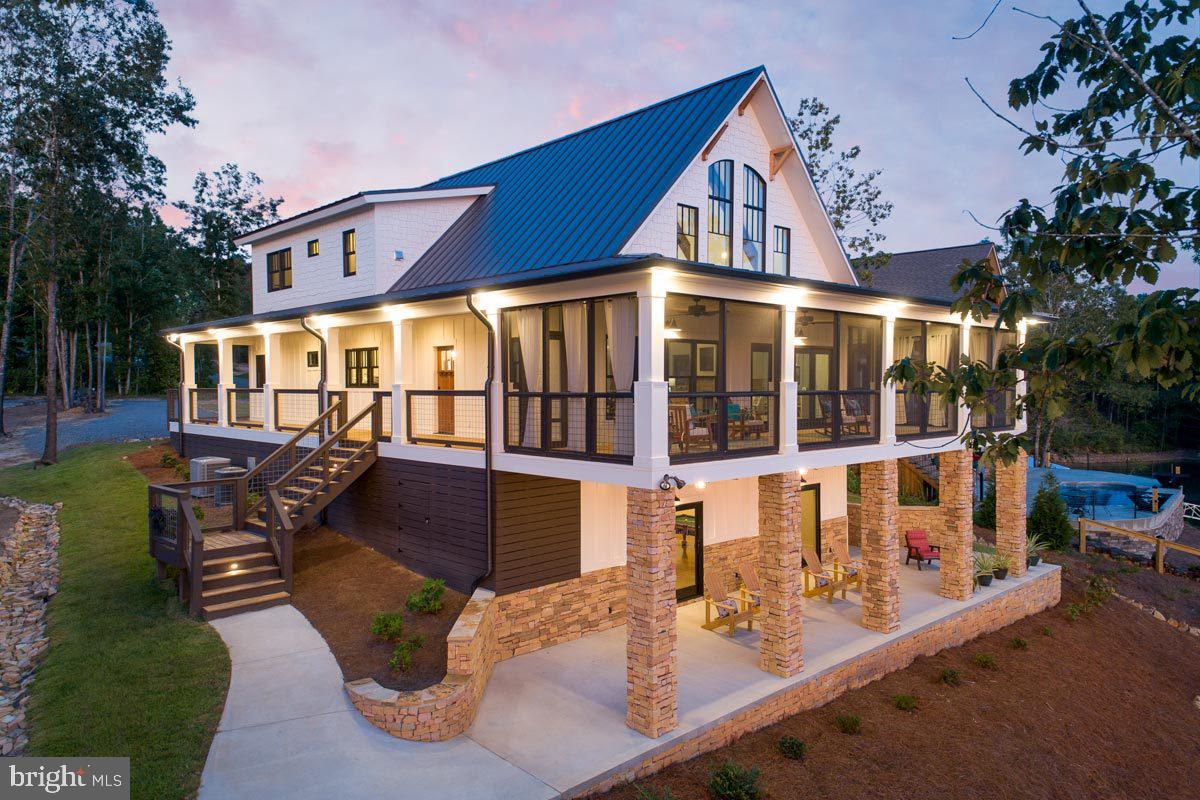 Escape the ordinary and build your dream in this riverfront community in Bentonville, VA, surrounded by the George Washington National Forest.

The proposed home plan is a true show-stopper, designed to capture views and maximize lifestyle. A wraparound porch spans three sides, including a screened section perfect for year-round enjoyment. Inside, a dramatic vaulted living and dining space creates an open, airy feel, anchored by a layout that blends comfort with wow factor.

The main-level primary suite offers privacy and convenience, while the upper level features additional bedrooms, each with walk-in closets, plus a loft overlooking the main living space. Need more room? The optional lower level provides space for a rec room, additional bedroom, and bath—ideal for guests or short-term rental potential.

Whether you bring this plan to life or design your own, this homesite offers the perfect backdrop for full-time living, a weekend escape, or investment opportunity.

River. Mountains. Privacy. This is Shenandoah Valley living done right.

Owner is a licensed agent. Pictures are AI renderings and some options shown may not be reflected in the price.