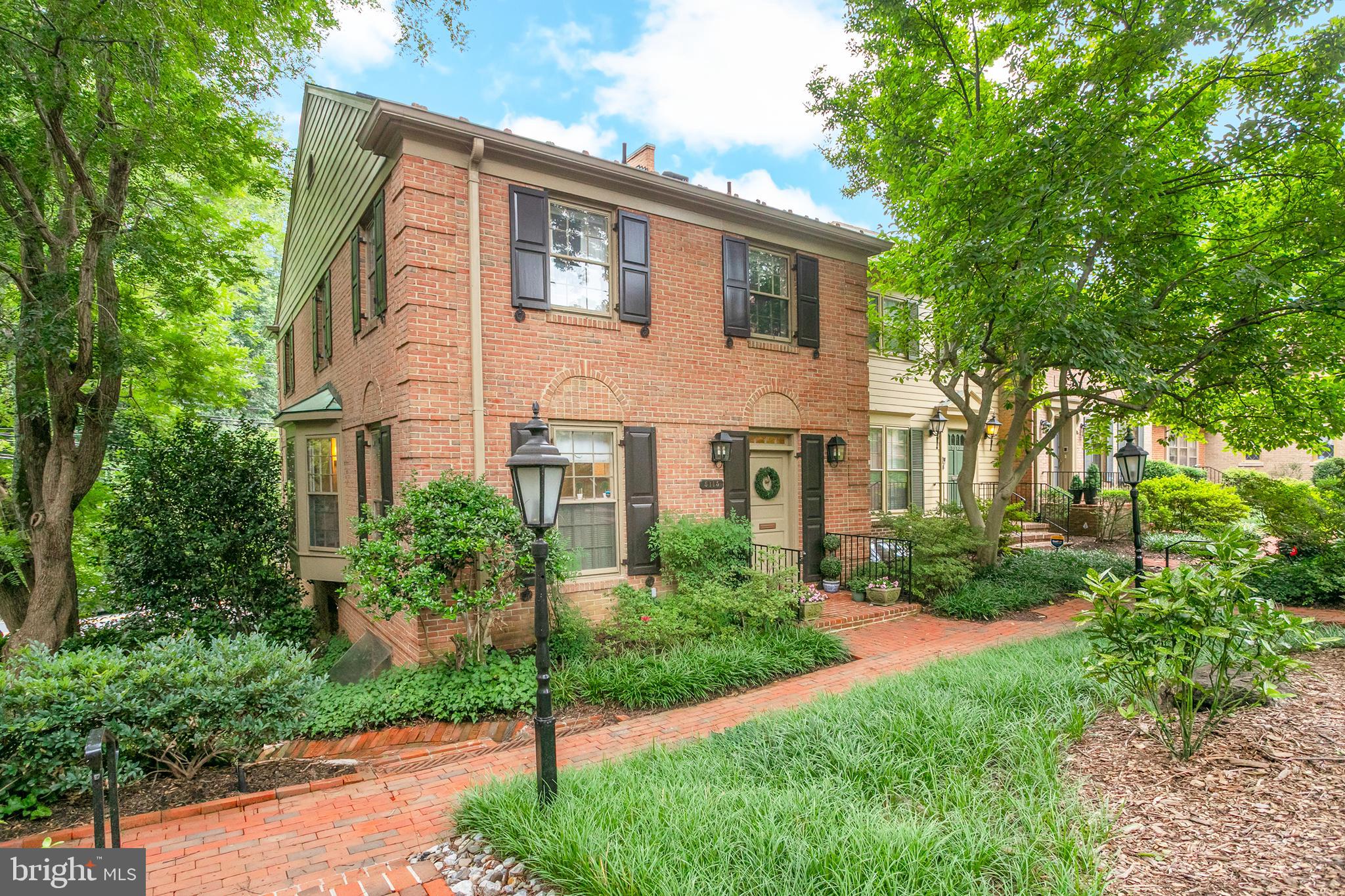 Welcome to this stunning semi-detached brick townhome on three levels, sited adjacent to the Capital Crescent Trail in highly desirable Westbard Mews. Offering four bedrooms, three-and-a-half baths, two gas fireplaces, and two reserved parking spaces, this residence pairs traditional architecture with thoughtful updates that make it truly one of a kind.

A gracious entry foyer sets the tone upon arrival, opening to a separate dining room framed by a bay window and custom built-ins — an elegant space for entertaining. Beyond it, the living room unfolds under tall windows that flood the room with natural light, anchored by one of the home's two well-maintained fireplaces (both regularly swept, most recently in 2024) and finished with classic crown molding. Refinished hardwood floors carry warmth and continuity across the main living areas. This level is complete with a powder room and a large closet for ample storage.

The gourmet kitchen was upgraded with new countertops, sink, and disposal, and has since been refreshed with new stainless steel appliances and painted cabinetry.  Enjoy the convenience of an eat-in space and ample natural light.

Upstairs, three comfortable bedrooms offer well-appointed private space. The primary bedroom is bathed in natural light from windows on two sides and features a convenient en suite bath, refreshed in 2026. Two additional bedrooms showcase custom wallpaper and generous closet space, sharing access to a second full bathroom on this level.

The lower level offers additional living space and high ceilings finished with new carpet, a second fireplace, and an updated bathroom, providing flexible room for a family room, home office, or guest space or au-pair suite. A wet bar and storage adds a natural gathering point for entertaining. The lower level also offers access to a private patio surrounded by mature landscaping, recently reimagined with tree removal and a full brick repaving in 2024, followed by a new brick surface in 2025 — creating a fresh, low-maintenance outdoor retreat with a key to the Capital Crescent Trail.

The home has been well cared for with replaced insulation in 2020 and annual HVAC maintenance, giving buyers added peace of mind. Westbard Mews Condominium lives like a townhome

5115 Westbard Avenue #1 offers a rare combination of classic townhome character, thoughtful recent upgrades, and unbeatable convenience to some of Bethesda's best shopping, dining, and transit — a must-see for anyone seeking timeless charm in a prime location.