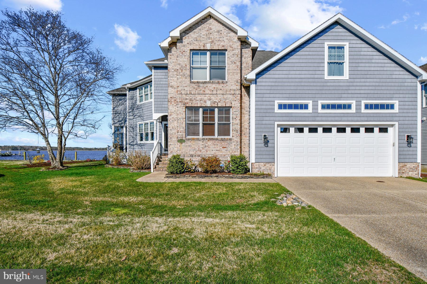 Welcome to a true waterfront masterpiece in the sought after community Ocean Pines in Berlin, MD. This custom built, 4 bedroom, 3.5 bath home spans over 3,400 square feet and was thoughtfully designed to capture breathtaking water views from nearly every room. Perfectly positioned on the lot, the home’s unique angles, expansive windows, and architectural detail create a one of a kind coastal retreat.

Step inside and immediately feel the impact. Sunlight pours through oversized windows, illuminating the stunning water backdrop. The grand foyer sets the tone with elegant arches, columns, and timeless character. The main level offers a seamless blend of functionality and beauty, featuring a private office or den with French doors, a sun drenched formal dining room, and a spacious living area with custom built ins. A convenient half bath and laundry room add to the thoughtful layout, while the show stopping sunroom provides the perfect place to relax and take in the views year round.

The kitchen is a centerpiece of the home. Spacious and inviting with abundant cabinetry, vaulted ceilings, and sightlines that extend to the water and the lofted upper hallway. Designed for both everyday living and entertaining, it features a curved island, double ovens, wine fridge, and plenty of prep and gathering space.

Upstairs, the primary suite is a private retreat with serene water views, dual walk in closets, and a luxurious ensuite bath complete with a soaking tub, separate shower, and double vanity. A second ensuite bedroom offers comfort and privacy for guests, while two additional bedrooms provide flexibility. One showcases wall to wall windows that frame the water beautifully. A large storage room is also easily accessible from this level.

Outside, the lifestyle continues. The expansive backyard overlooks the water and is designed for both relaxation and recreation, featuring a paver patio ideal for entertaining. The private dock with boat lift offers direct access to the water, making this home a dream for boating enthusiasts.

Complete with a 2 car garage and exceptional craftsmanship throughout, this Ocean Pines waterfront home is truly a showstopper, where every detail was designed to maximize views, comfort, and coastal living at its finest.