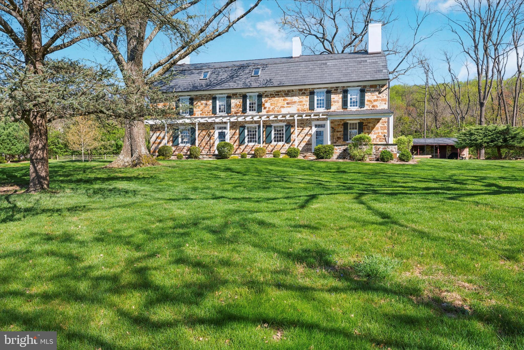 Welcome to the Thomas Downing Estate where your dreams of owning a historical home can finally become a reality.  Steeped in history from a former barn on the original 870 acre property being used as a hospital during the American Revolution to having the original town of Milltown referred to as Downing’s Town then officially renamed Downingtown. Tucked away on 8 tranquil acres offering pastoral and treed views from every window you will be transported back in time to an era of grandeur.  
This magnificent home was built over 3 centuries ago with expansions and updates over the years. It exudes a true sense of timeless elegance beginning with the gambrel roofed exterior and throughout the interior with endless wide plank wood floors, original millwork, lots of windows with deep sills, and 10 fireplaces.   As you approach via the private road and turn onto the circular driveway you will be awed by the magnificence of this stone and stucco home and grounds.  The warm and welcoming slate front porch along the entire front offers a breathtaking and private view of nature at its finest and absolutely screams WELCOME HOME.  
As you step inside the front door you will be in the foyer with natural light streaming in from the large transom over the door.  Here you will find the turned staircase tucked in the back as well as the beginning of the lovely millwork.  To the right you will find the formal dining room with an elegant marble surround fireplace and a slate hearth.  To the left of the foyer is the inviting formal living room with a fireplace offering a finely detailed surround and hearth, a built-in bookcase and large windows with deep sills. Tucked just off the living room is a small room with a stone wall that would make a great study and next to that is the powder room.  On this floor you will also find the spacious, bright and cheerful “heart of the home” family room.  This room boasts a massive stone surround with slate hearth walk-in fireplace and beamed ceiling that will surely take you back to yesteryear when this room was the hub of the family living space. The family rm has space for an informal eating area.  Just off the family rm you will find the spacious island kitchen with skylights that fill the room with natural light. The stone cook’s fireplace is a magnificent focal point of the rm and will surely transport you back in time.  The kitchen updates offer stainless appliances, lots of counter and cabinet space and a butler’s pantry that is like a 2nd kitchen with an abundance of storage, a wine cooler and door to the outside.  There is also a spiral staircase to the 2nd floor.  Also off the family room you will find a fireside room that would make a perfect den or study. The 2nd fl offers a large fireside master bedrm w/ double closets along with a large walk-in dressing room with lots of closet space and, amazingly, another fireplace.  Just off the master bedrm is a large bathrm with double bowl vanity, platform tub, separate shower and, yes, another fireplace.  On this flr you will find another large bedrm with a fireplace and just down the hall is bedrm #3 with nice closet space, a fireplace of course and ensuite full bath which also showcases another fireplace. Just off bedroom #3 is access to the spiral staircase leading to the kitchen for a quick sneak downstairs for a snack.   
On this floor you will also find the conveniently located laundry rm with plenty of storage/workspace.
On the 3rd flr you will find a large loft area that could be used as a bedrm, two additional large bedrms, one with a wood stove, a full bath and two large unfinished rooms that were originally the meat house area. On the lovely grounds you will find many mature trees, a 2 stall stable, corn crib, well house and beautiful stone walls.  As you will recognize after your first visit, this home has been lovingly restored and updated over the years with modern amenities seamlessly integrated into the historic architecture.