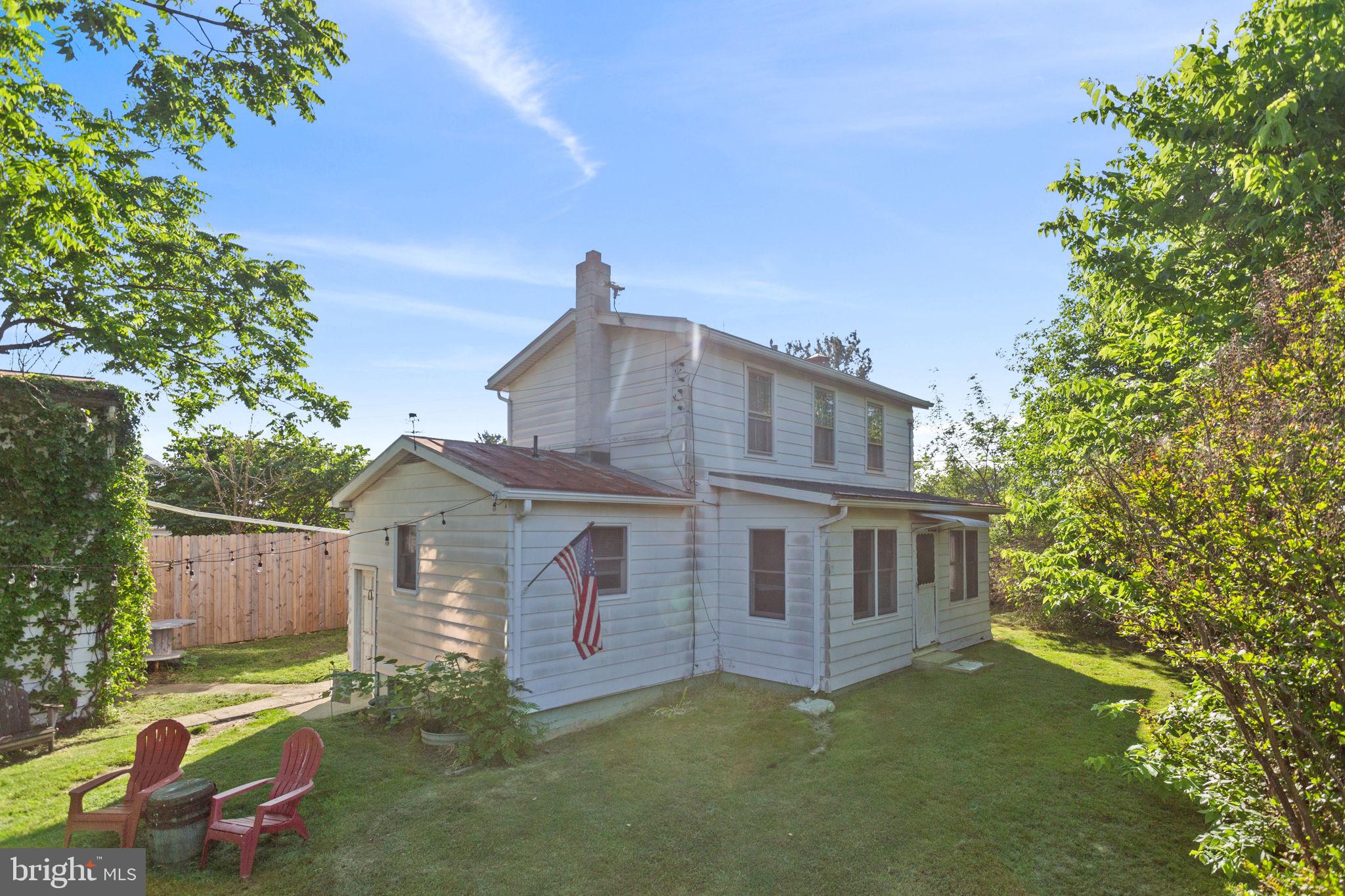 Welcome to this charming, renovated farmhouse conveniently located between the towns of Timberville and Broadway! The enclosed front porch welcomes you to read a book, paint, have a quiet office space, etc. If you wish your visitor to come into your home, this leads into a warm and inviting living room featuring a beamed ceiling, shiplap accent wall, and beautiful wood flooring. The main level also offers a comfortable bedroom full bath and laundry. The country kitchen boasts abundant cabinet space, updated appliances, a flue with woodstove, wood flooring, and access to a side porch ideal for a drop zone and pantry storage. Upstairs, you'll find two spacious bedrooms. Enjoy the privacy of the partially fenced backyard, perfect for relaxing evenings around the firepit. Take in lovely views of surrounding fields and mountains from the front of the home. Lots of storage in detached building. Conveniently located near shopping, dining, hardware stores, and the community park along the North Fork of the Shenandoah River, with easy access to I-81 and major airports within two hours.