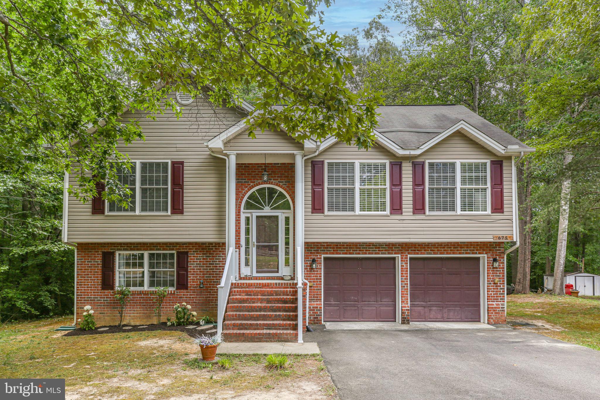 Completely renovated and thoughtfully improved from top to bottom, 675 Welsh Drive offers buyers the rare opportunity to move into a home where the major work has already been done. Recent improvements include all-new flooring throughout the home, a brand-new HVAC system, resurfaced rear deck, new exterior railing, new stainless steel microwave, stove, and dishwasher, plus a beautifully renovated lower-level full bathroom featuring a new shower, toilet, and flooring. To provide additional peace of mind, the sellers have also completed a pre-listing home inspection, allowing buyers to move forward with confidence knowing the home has already undergone a thorough evaluation and significant investment in its upkeep. Tucked within the gated community of Lake Land'Or and surrounded by mature trees, this beautifully updated home offers the perfect balance of privacy, flexibility, and access to an exceptional collection of community amenities. Inside, soaring vaulted ceilings, open sightlines, and a dramatic staircase create an immediate sense of space and openness. The living room serves as the heart of the home, offering a welcoming setting for both everyday living and entertaining. New flooring and fresh updates throughout create a move-in-ready feel that allows the next owner to simply unpack and enjoy.
The kitchen has been refreshed with brand-new stainless steel appliances and opens conveniently to the main living areas, creating a comfortable flow for gatherings both large and small. One of the home's most impressive features is the fully finished lower level. Complete with a newly renovated full bathroom, generous living area, excellent storage, and direct access to both the garage and backyard, this level functions beautifully as a private guest suite, multi-generational living space, home office area, recreation room, or a combination of all four. The flexibility it offers is difficult to find in today's market. Outside, the private backyard is framed by mature trees that create a peaceful natural setting. The newly resurfaced rear deck provides the perfect place for morning coffee, outdoor dining, entertaining, or simply enjoying the wildlife and wooded views that the sellers have treasured over the years. Beneath the deck, additional space offers future potential for a patio or expanded outdoor living area. The oversized garage extends beyond simple vehicle storage and includes a dedicated workshop area, built-in workbench, shelving, and an additional refrigerator/freezer that conveys with the property. Combined with the long paved driveway and abundant storage throughout the home, functionality and practicality are woven into every aspect of the property. Beyond the home itself, Lake Land'Or offers a lifestyle many buyers dream about. Residents enjoy 24-hour security, multiple swimming pools, playgrounds, clubhouse facilities, beaches, lake access, and abundant opportunities to enjoy the outdoors. The combination of water, nature, mature landscaping, and established amenities creates a community that feels like a year-round retreat. With major systems updated, renovations completed, a pre-listing home inspection already performed, and a location that blends privacy with resort-style amenities, 675 Welsh Drive offers a truly turnkey opportunity within one of the area's most amenity-rich gated communities.