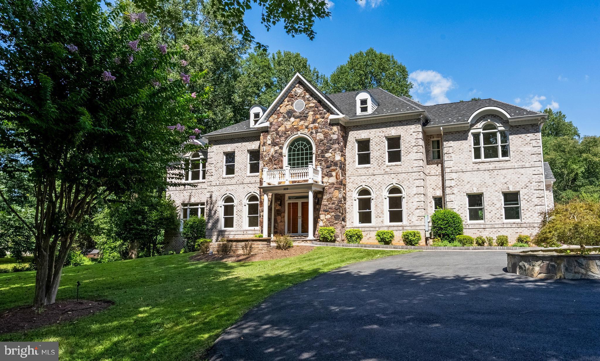 Tremendous price adjustment!  A Private Oasis for all Seasons  Discover a timeless retreat nestled in a prime location,  across from Meadowlark Botanical Gardens and minutes to downtown Vienna, Tysons Corner, the Metro Silver Line, Dulles International Airport and more!  Brick and Stone Colonial sited on a tranquil lot, offers 8900 square feet of fine living.  Designed for grand entertaining and intimate gatherings alike, the home features an elegant two-story foyer opening to spacious rooms with stunning garden views.  The Chef's Dream Kitchen is a culinary haven with a breakfast area, wet bar, butler's pantry, dual sinks and dishwashers.  The upper level's sumptuous Primary Suite has a sitting area, balcony overlooking the back lawn, gas fireplace, and a bathroom featuring a jetted whirlpool tub, separate shower and dual vanities.  Each additional bedroom has its own ensuite bath and walk-in closet, ensuring comfort and privacy for all.  The walk-out lower level is an entertainer's paradise, featuring a wet bar/kitchen area and expansive gathering spaces.  An additional bedroom and full bath make the lower level ideal also for long-term guest visits, multi-generational and au pair living.    Three-zone heating and air conditioning, masonry gas fireplaces, elegant stone and hardwood floors make this a well-built home designed for year-round enjoyment.   Outside, enjoy sitting in a pretty gazebo and watch your personal orchard that includes apple,  peach and persimmon trees, along with a blueberry bush bear fruit in season.  Space for an in-ground pool and ample parking further enhance the property's appeal.  Experience the perfect blend of well proportioned rooms,  function and location in this exceptional property.