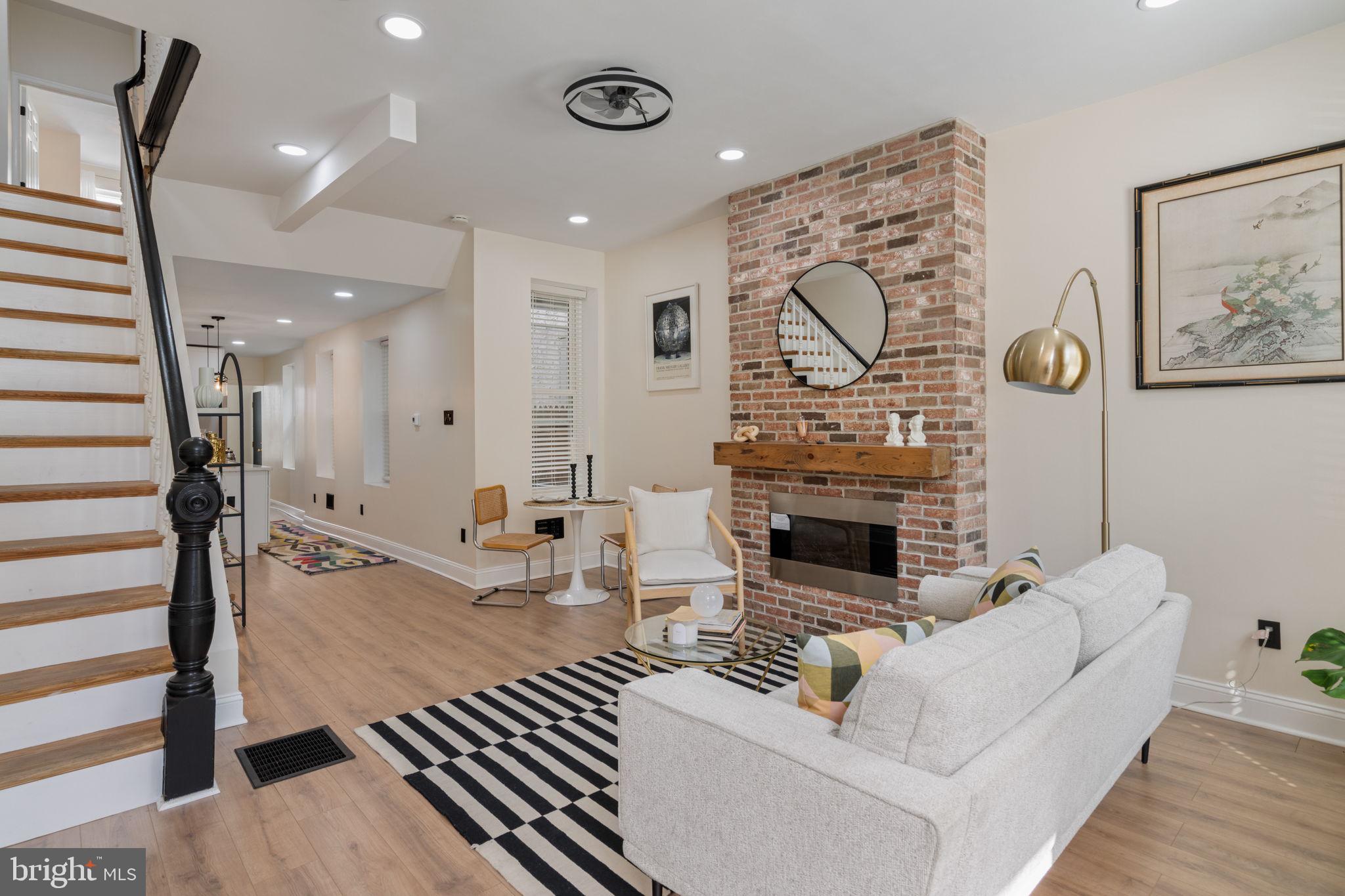 Welcome to 856 Perkiomen Street, where thoughtful modern updates and classic Philadelphia character come together in the heart of vibrant Francisville!
This beautifully renovated 5-bedroom, 2.5-bath rowhome offers an impressive amount of space, style, and function, all on a charming, walkable block surrounded by the neighborhood's iconic rowhomes and tree-lined streets. With parks, restaurants, cafes, and Center City just minutes away, you'll enjoy the convenience and energy that make Francisville one of Philadelphia's most desirable neighborhoods.
A sleek exterior welcomes you inside to a bright and spacious living room filled with natural light. While the home has been thoughtfully updated from top to bottom, select original details - including the stunning staircase railing - preserve a touch of its historic charm. A striking fireplace anchors the main living space, creating a warm and inviting atmosphere for everyday living and entertaining.
The beautifully updated kitchen features new cabinetry, modern appliances, generous counter space, and abundant natural light. Just beyond, a convenient powder room and first-floor laundry area add everyday functionality before leading to a private rear yard - perfect for gardening, grilling, or simply relaxing outdoors.
Downstairs, the clean and spacious basement provides excellent storage and offers plenty of potential for a workshop, hobby space, home gym, or future customization.
The second floor includes three generously sized bedrooms and a large full bathroom. Dual-zone HVAC ensures comfort throughout every season.
Occupying the top floor, the primary suite serves as a true private retreat, complete with a walk-in closet and a beautifully appointed ensuite bathroom featuring a double vanity, soaking tub, and separate shower. An additional bedroom on this level provides flexibility for guests, a home office, nursery, or additional living space.
Lovingly reimagined and move-in ready, 856 Perkiomen Street offers a rare combination of modern convenience, generous living space, and timeless Philadelphia character. All that's left to do is move in and make it your own!
