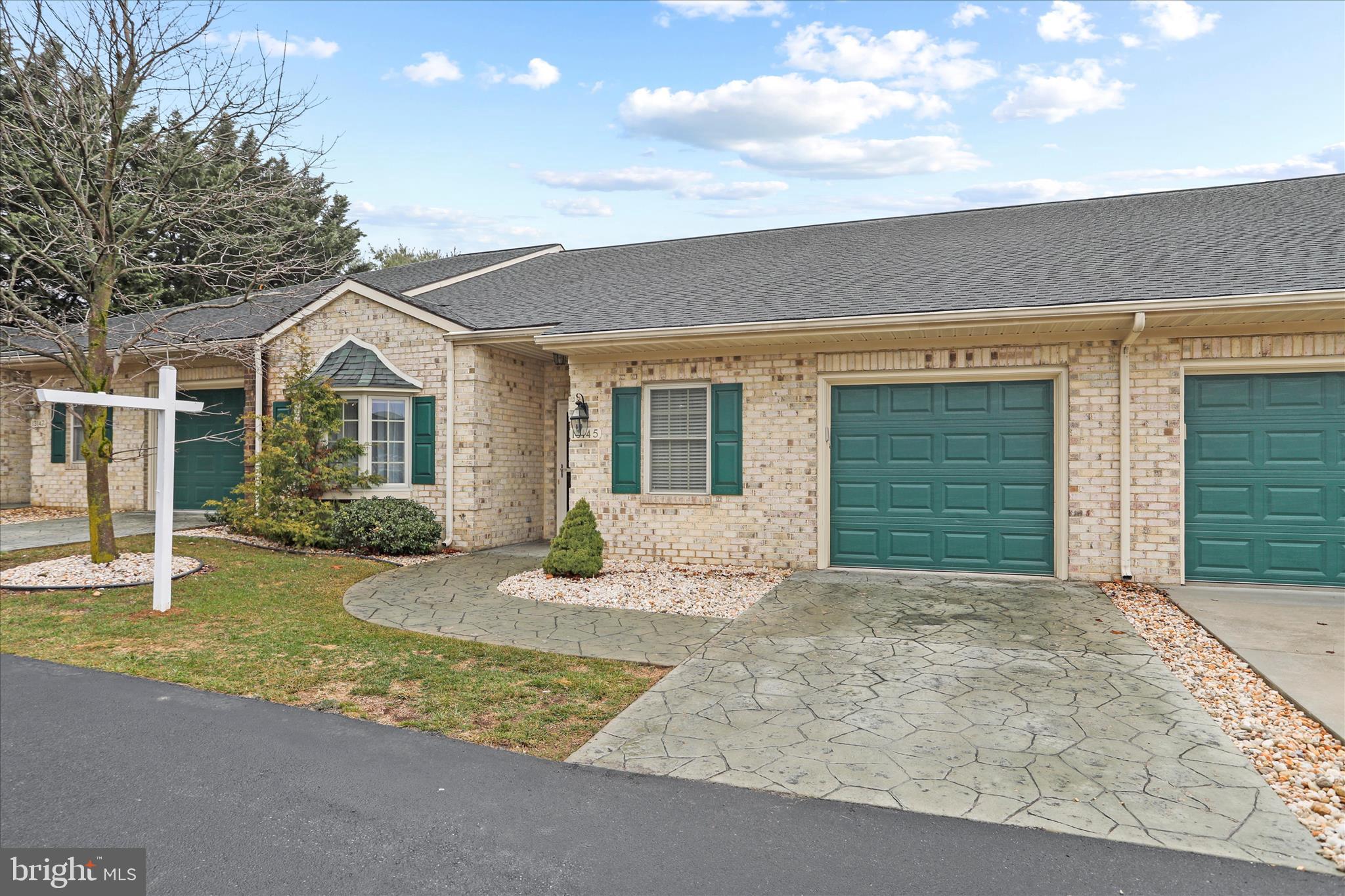 Situated in the desirable Cortland Manor, this home offers an open floorplan with beautiful hardwoods/tile in the main living spaces and 9’ ceilings throughout. The kitchen is spacious and functional, featuring plenty of cabinetry, a breakfast bar, and a seamless transition into the dining area.  The sunroom is a cozy space that opens to a covered porch with a stamped concrete patio.  Additional features include an office room off the main living space and ample storage throughout the home. The large primary suite includes a primary bathroom. Enjoy the perks of low-maintenance living with a low monthly condo fee that covers lawn care, snow removal, trash and overflow parking. Conveniently located near shopping, dining, and commuter routes.