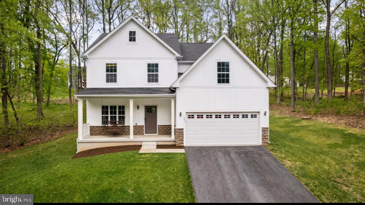 OPEN HOUSE Sunday, June 7 from 12 to 2 PM  *** Welcome to 237 Speaks Lane, a beautifully refreshed 5-bedroom, 3-bath home in the sought-after Lake Forest Estates community—offering the feel of brand new construction without the wait. Nearly every detail has been recently updated, including fresh paint, new flooring, trim, and finishes throughout—creating a clean, modern, move-in ready home that truly feels like new from the moment you walk in. The main level features a bright, open-concept layout with spacious living and dining areas, a cozy gas fireplace, and abundant natural light. The kitchen is designed for both everyday living and entertaining, complete with granite countertops, stainless steel appliances, ample cabinetry, pantry, and a large center island. At the front of the home, a versatile flex room offers the perfect space for a home office, formal dining room, sitting area, or playroom. A main-level bedroom and full bathroom provide ideal flexibility for guests, extended stays, or multi-generational living. Upstairs, the primary suite is a true retreat featuring two walk-in closets and a spa-inspired bathroom with dual vanities, a private water closet, soaking tub, and a separate walk-in shower with floor-to-ceiling tile. Three additional bedrooms are located on this level along with a full bath and a convenient upper-level laundry room, thoughtfully positioned near the bedrooms for everyday ease. The walkout lower level is unfinished, offering excellent storage and incredible potential for future living space. Already equipped with a bathroom rough-in, it’s ready to be customized to suit your needs—whether that’s a rec room, guest suite, or additional living area. The home also includes a high-efficiency water treatment system, adding comfort and long-term value. Step outside to enjoy a rare, mostly flat backyard with just the right amount of tree coverage to provide privacy without the upkeep—open, usable, and ideal for everyday living, entertaining, or simply relaxing outdoors. Set on a 0.59-acre lot with a covered front porch and 2-car attached garage, this home offers both comfort and functionality. Located in Lake Forest Estates, residents enjoy access to private lake amenities including fishing, kayaking, swimming, trails, and more—creating a lifestyle that blends nature with everyday convenience. Just minutes from commuter routes, shopping, and dining, this home combines privacy, updates, and functionality in one exceptional package.