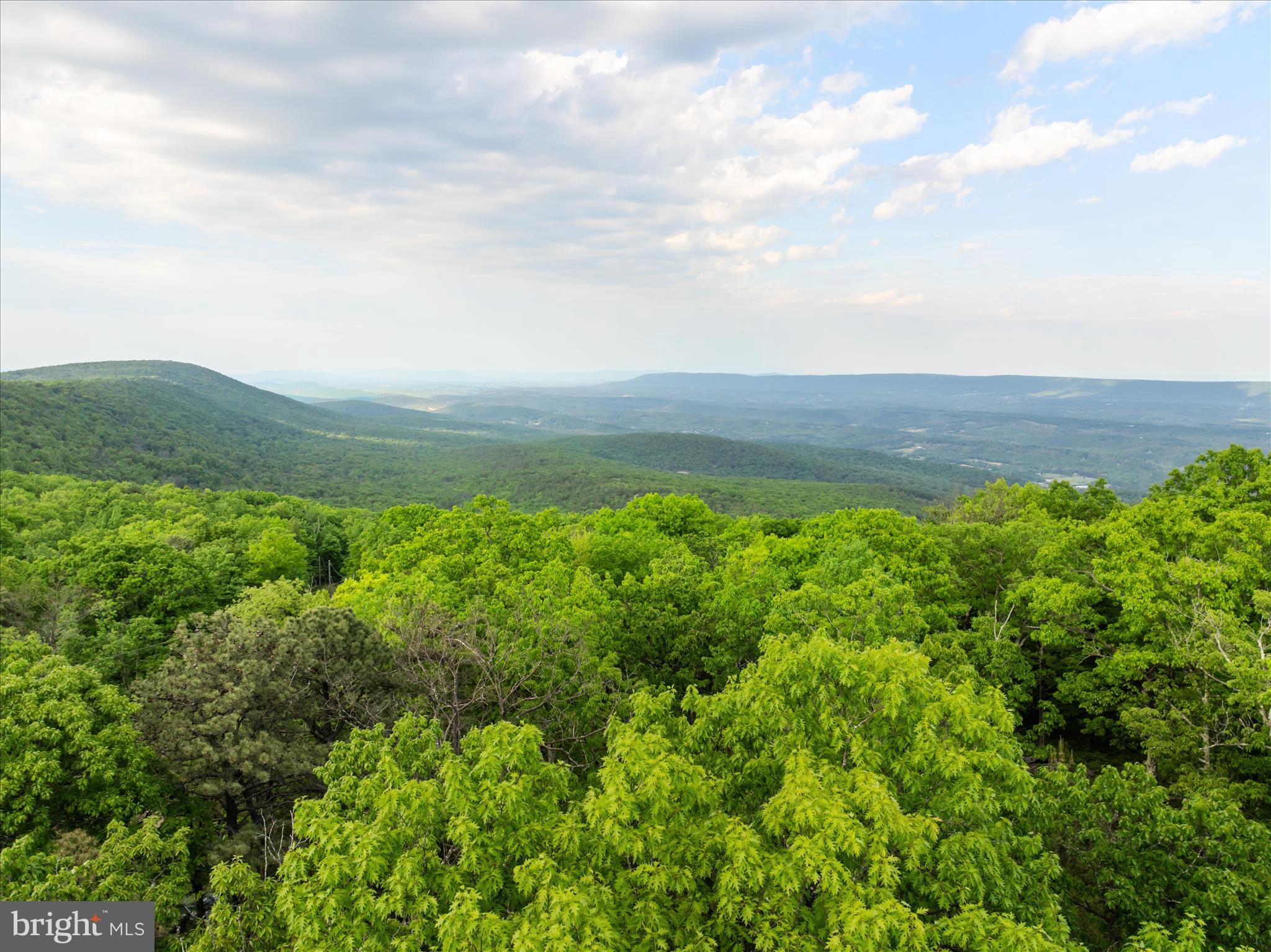 Perched atop Cacapon Mountain, this spectacular 10-acre estate parcel offers the ultimate blend of high-altitude privacy and turnkey building readiness. Located within a prestigious gated community, this rare property eliminates the headaches of raw land development. It features a fully installed well and a septic system already perc'd and ready for a 3-bedroom dream home. Close to historic Berkeley Springs and Winchester, Virginia. Skip years of permitting and site prep. Bring your builder, bring your blueprints, and start living your mountain dream today!