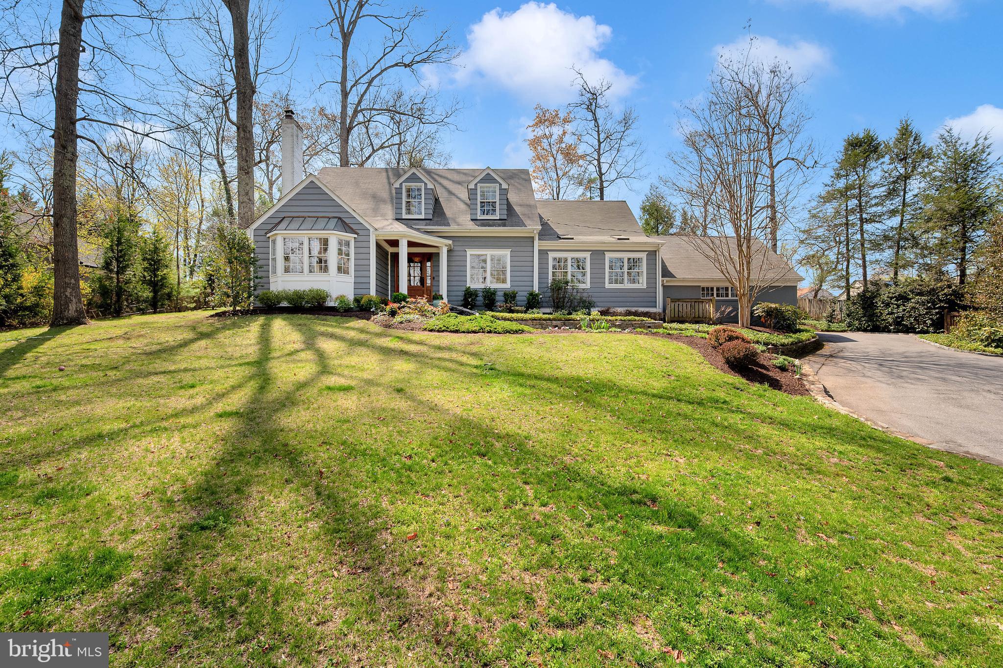 Situated in the quiet and scenic neighborhood of Congressional Forest Estates, this expanded and meticulously maintained Cape Cod sits on a gorgeous 0.63-acre private lot. The property’s beautiful setting is immediately evident as coming up the driveway. The home is an outdoor enthusiast’s dream, featuring extensive hardscaping, professional landscaping, and a secluded backyard complete with a privacy wood fence, custom lighting, a newly constructed firepit, and an inviting screened porch designed for seamless indoor-outdoor hosting.

The main level is defined by its bright and functional flow, a welcoming foyer is flanked by a spacious light-filled living room with a wood-burning fireplace on one side and and an elegant dining room on the other. The back of the home is anchored by a remodeled kitchen features gas cooking, abundant cabinetry, and peninsula seating that opens into a breakfast room with direct access to the porch. Adjacent to the kitchen, the family room includes custom built-ins and pocket doors for added versatility. This floor also provides a convenient guest bedroom and a remodeled full bath, alongside a practical mudroom with built-in cubbies that connects directly to the driveway and two-car garage.

Upstairs, the primary suite serves as a true retreat, offering three closets and a renovated bathroom equipped with a double vanity, a walk-in shower, a classic clawfoot tub, and heated floors. The suite also includes an adjacent private den, ideal for a home office, yoga studio, or gym. Two additional generously sized bedrooms and a renovated hallway bath complete the upper level. 

The lower level adds further flexibility with a semi-finished recreation room and a half bath, as well as a large storage area that currently functions as a laundry room and secondary exercise space. The driveway provides ample space for up to five cars in addition to the two-car garage. 

Combined with its premier Bethesda location, this home offers a perfect balance of classic charm and modern amenities.
