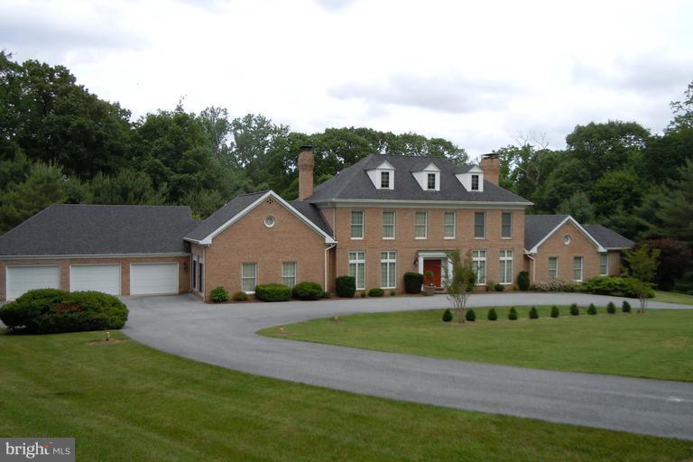 Exquisite Georgian style home features top of the line appliances and granite countertops,  Au pair/guest suite.  Separate cabana kitchen and his and her baths serve pool area. Paneled library, family room, great room and living room. Perfect for families and entertaining. Chandelier in Sunroom excluded