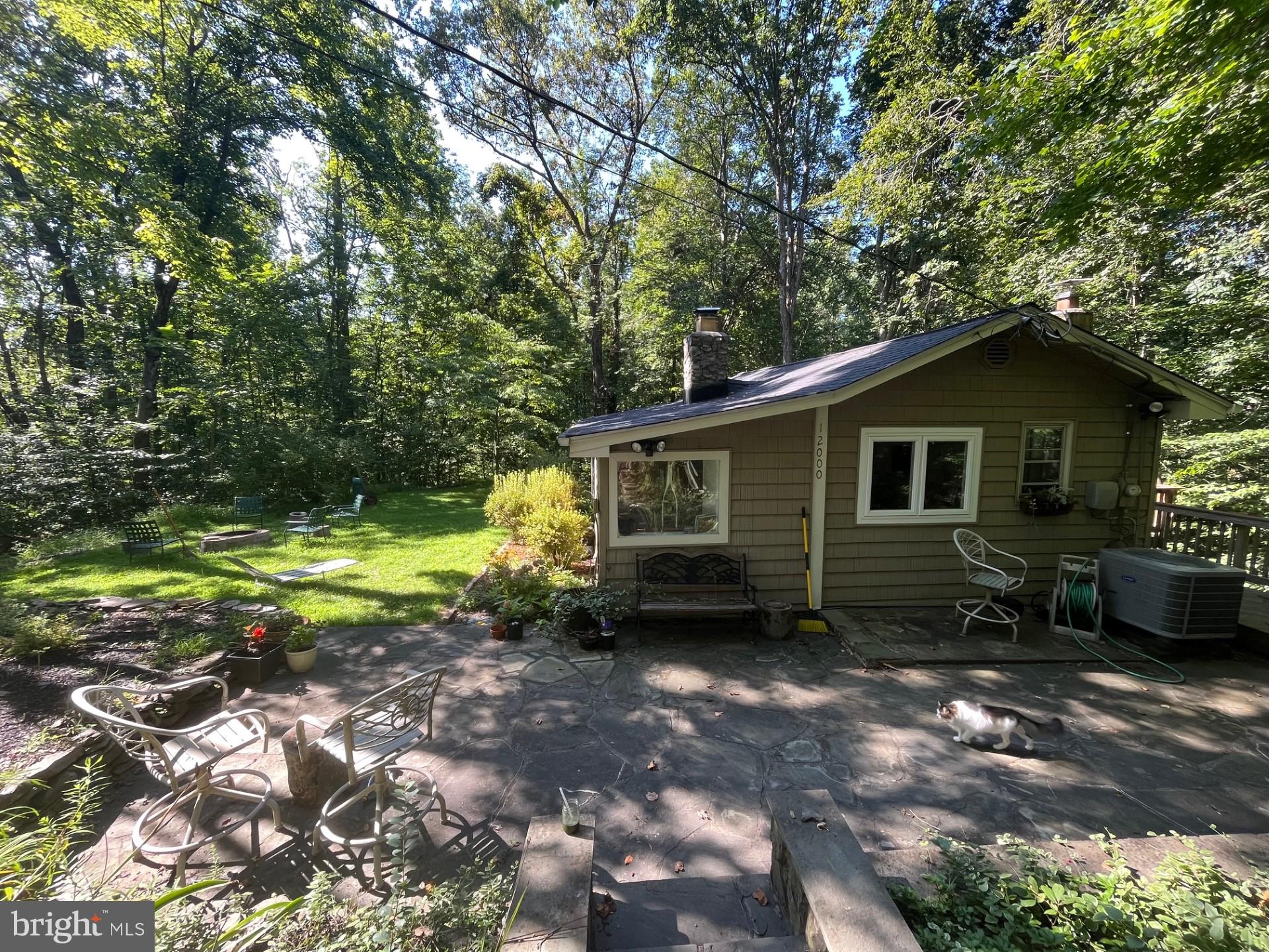 Updated Woodland Retreat with Modern Systems -Surrounded by mature trees and year‑round natural beauty, this charming cabin offers a peaceful escape with thoughtful updates throughout. The bright 2020 kitchen remodel features wall removal to open the space while giving a brighter more functional layout and added new cabinetry, flooring, and windows, opening to warm, inviting living spaces anchored by a stone fireplace. Major system improvements include a 2021 roof with transferable 50‑year warranty, 2024 hot water heater, 2024 chimney liner and cap, and 2024 septic pump and repair and a 2019 HVAC. A **new 2025 washer** adds to the home’s move‑in readiness. Whether you're seeking a full‑time residence or a weekend getaway, this property blends rustic comfort with modern reliability.  
*Professional photos scheduled. Tenant occupied — limited showing windows; please schedule in advance.*