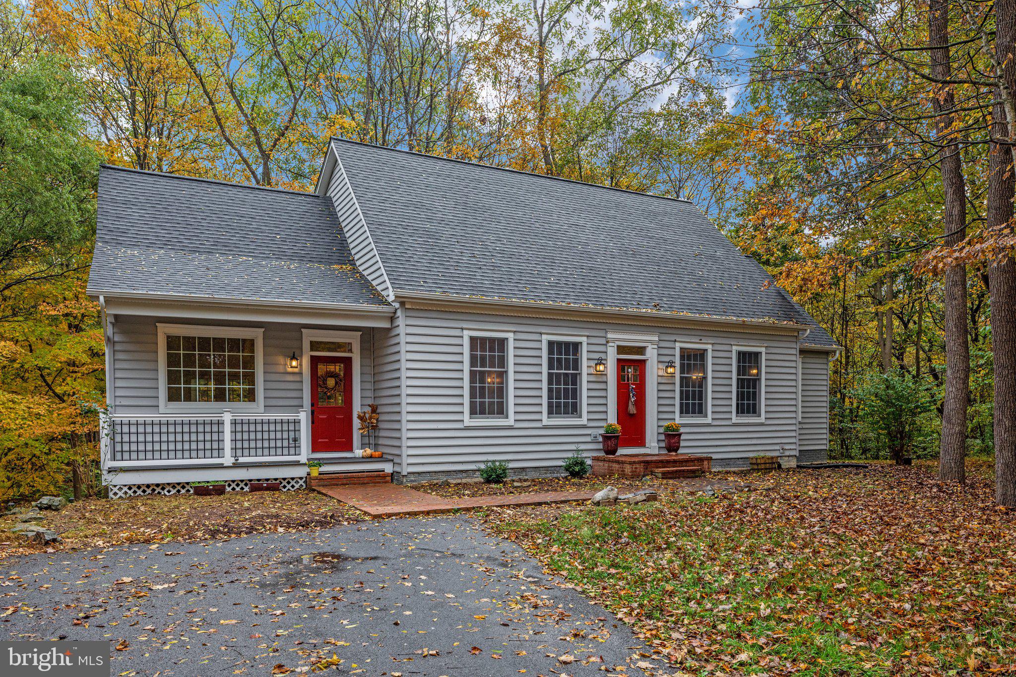 HUGE PRICE ADJUSTMENT!! Take advantage of a rare opportunity to own a property in the Terrapin Neck location set in the outskirts of historic Shepherdstown, WV.  This peaceful, partially wooded home site awaits!  Choose your entrance from the covered front porch or bricked front porch steps, the entry inviting  with immediate gorgeous aesthetics of the open great room.  new gleaming oak hardwood floors run throughout the main living area with soaring cathedral ceilings.  The cozy fireplace is flanked by hand crafted, wooden mantle and bookshelves.   The gourmet kitchen is truly the heart of this open great room, featuring upgraded cabinetry with glass doors, new stainless appliances, wall oven, built-in wall microwave, farmhouse sink, gas stove, and quartz counter tops w/ eat-up island overlooking the spacious formal dining area.  The master bedroom suite is conveniently located on the main floor, offers new carpet, soaking tub, separate shower, double vanity, and large walk-in closet complete with shelving to stay organized.  Easily access your at-home office or separate living area, also located on the main floor via french doors.  Half bath completes the main level.  Upstairs, you'll find two spacious bedrooms, a full bathroom, and laundry room.  Lower level is freshly painted and carpeted, and offers a large rec room, separate room, and unfinished area, perfect for storage.  Step outside to discover this serene setting.  Easily access the screened in trex deck from the great room that leads to open trex deck with stairs to the treed, fenced rear yard.  Patio is located at the basement entrance and smartly situated under the covered screened porch.  Picture perfect barn with large overhang and wired for electric & running water is the focal point of the partially wooded property.  Let's talk about the new:  New Long roof with architectural shingles & new gutters (with 25 yr transferrable warranty), new quartz counter tops, kitchen sink & faucet, new exterior front doors, new oak plank floors on main level, new appliances, new master bath floor & toilet, new carpet throughout, front exterior doors & sliding glass door in basement, trex front porch and trex rear deck.  This upgraded packed dream home is move in ready and settled on 2.13 wooded unrestricted acres offering the convenience of small town Shepherdstown with dining, shopping, recreation and culture to bring you a unique home package.
