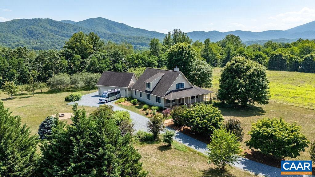 Set on 3.82 private acres in The Levels, this Arts & Crafts home delivers bold Blue Ridge Mountain views and a peaceful setting on a quiet cul-de-sac, accented by trees from a former apple orchard. Built in 2005 by Roger Gunden of Stagebridge Construction, the 1.5-story home offers 4 bedrooms, 3.5 baths, and a 3-car garage. At the heart of the home, the vaulted, cathedral-ceiling great room and gas log fireplace anchor the main living space, with a wall of windows framing panoramic mountain views. The kitchen features an island, granite and quartz counters, a double wall oven, and gas cooktop. The main level offers a primary suite plus a bedroom and full bath. Upstairs, two bedrooms share a full bathroom with walk-in storage closets; the front bedroom takes in a spectacular mountain view over the porch. Step out to the front or side porch to take in the views, or relax on the deck. A bonus room off the garage, with its own half bath, suits a gym, hobby, or studio. Highlights: encapsulated crawlspace, garden spot, storage shed, and Firefly Fiber internet. HOA is $300/year for road maintenance and snow removal. Enjoy easy access to Rt. 151 wineries and breweries, the Nelson Farmers' Market, and Charlottesville and Waynesboro.,Granite Counter,Quartz Counter,Fireplace in Great Room