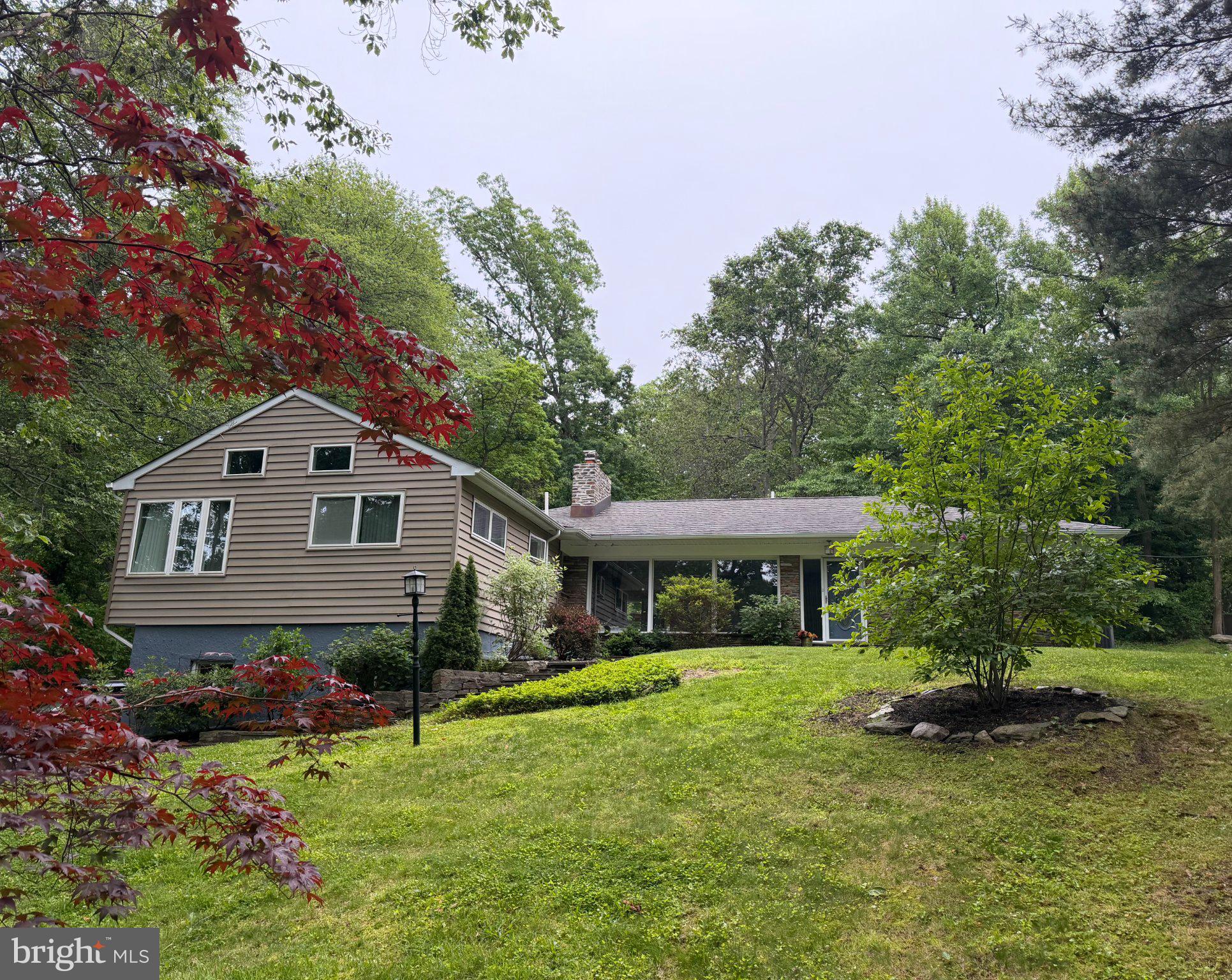 Some homes have features. This one has a feeling. Nestled on a private, wooded 0.62-acre lot in Huntingdon Valley, 2115 Willow Brook Drive offers something increasingly rare: genuine peace and quiet. Floor-to-ceiling windows flood the main living areas with natural light while framing views of mature trees, visiting deer, foxes, and the kind of stillness that makes you forget how close you are to everything.

The home delivers on every practical level too. Three bedrooms, three full baths, two half baths, 2,319 square feet of above-grade living space plus a finished basement complete with a wall-mounted split system - ideal for a media room, gym, or additional living space. Hardwood floors, a wood-burning fireplace, and radiant floor heating. A skylighted home office with built-in shelving adds versatile flex space ideal for working from home or a private studio. New water lines installed by the Township in 2026. Heated garage professionally waterproofed by AquaDry. Interior basement by Jamison Waterproofing, and crawl space fully remediated by Groundworks - all three are gold-standard companies in their fields. Chimney completely relined and repointed by American Chimney and ready for a gas insert if new owners want to go in that direction. All work done by highly reputable, well-known contractors. Water management work all comes with lifetime transferable warranties.  

Elevated wooded setting with natural stone landscaping throughout.

Additional photos coming June 12. 
Showings begin June 13. 
Open House Sunday June 14, 11am to 3pm. 
Seller is a licensed PA real estate agent.