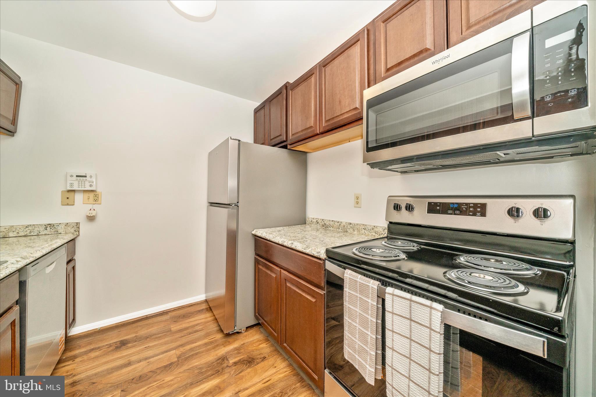 PRICE IMPROVEMENT!!! Discover easy, low-maintenance living in this beautifully refreshed 2 bedroom, 2 bathroom ground-level condo located in the sought-after Cromwell Fountain community. Freshly painted throughout and featuring stainless steel appliances that are less than 2 years old, including a brand-new stove, this move-in-ready home offers comfort, convenience, and a functional layout perfect for everyday living.

The spacious living room features a cozy wood-burning fireplace and direct access to a private patio overlooking common grounds — an ideal spot to relax and unwind. The kitchen includes a breakfast bar that opens to the main living area, creating a seamless flow for entertaining or casual dining. A full-size washer and dryer are also conveniently located within the unit.  The primary suite offers a private full bath and generous closet space, while the second bedroom and additional full bath provide flexibility for guests, a home office, or additional living needs.

Enjoy the convenience of ground-level living with secure building access, plus a location close to shopping, restaurants, parks, and major commuter routes. Whether you are a first-time buyer, downsizing, or looking for low-maintenance living, this condo is ready for its next owner.