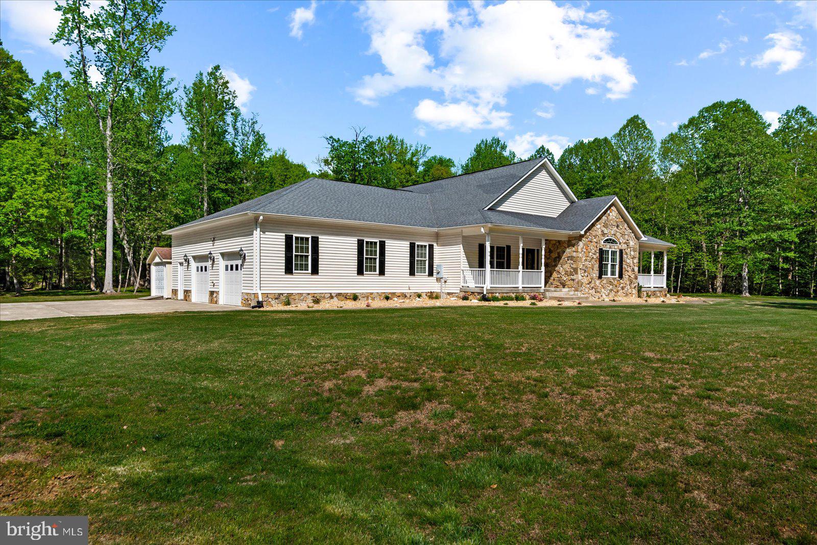 Welcome to your own private retreat in the heart of King George County, where peaceful country living meets convenience and comfort. Nestled on 10 wooded acres, this beautifully maintained home offers more than 2,700 square feet of thoughtfully designed living space, perfect for both everyday living and entertaining.

Step inside to discover tall ceilings, abundant natural light, and an open, inviting floor plan that immediately feels like home. The spacious eat-in kitchen serves as the heart of the home and features a brand-new wine fridge, making it ideal for hosting guests or relaxing after a long day. A separate dining room provides additional space for gatherings, holidays, or formal dinners.

The primary suite is truly a standout feature, offering a massive walk-in closet filled with natural light — a rare and highly desirable touch that adds both function and character.

Outside, the property continues to impress. Sip your morning coffee on the covered front porch or enjoy evenings on the expansive patio beneath the pergola, all while overlooking the large, flat backyard surrounded by mature woods for ultimate privacy and tranquility.

Designed with both practicality and versatility in mind, the oversized two-car garage provides ample room for vehicles, storage, tools, or hobbies, while the large storage shed offers even more functional space for equipment and outdoor needs.

Conveniently located just minutes from Colonial Beach, Naval Support Facility Dahlgren, and within easy reach of Fredericksburg, this property offers the perfect blend of seclusion and accessibility.

If you’ve been searching for a home that offers space, privacy, functionality, and a true sense of escape, this exceptional King George property delivers it all.