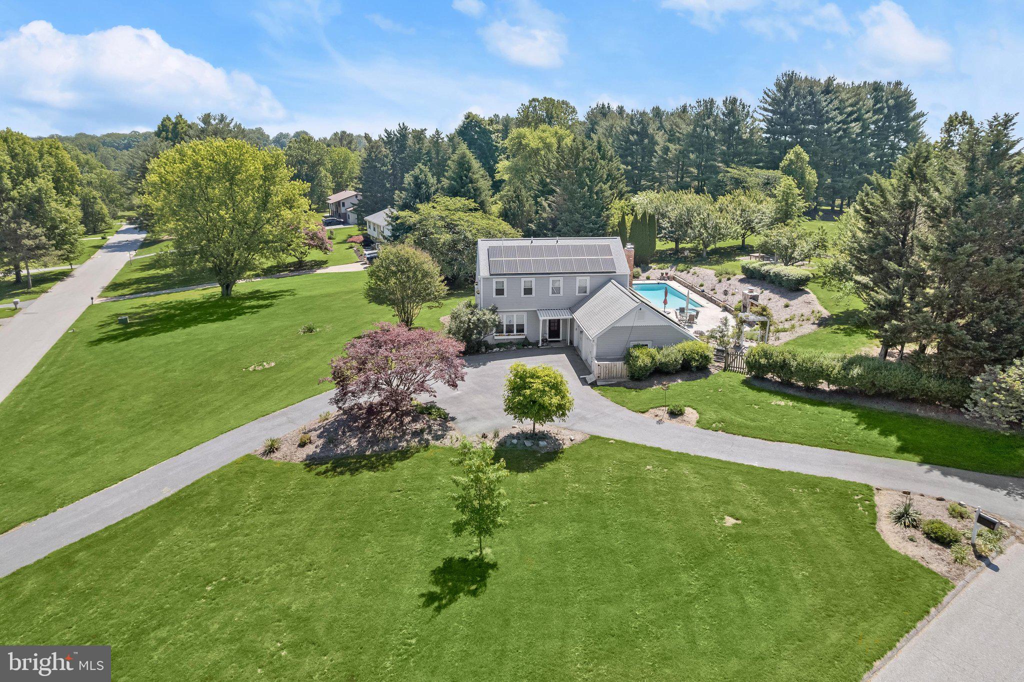 Introducing this exceptional five-bedroom, four-bathroom home set on a double corner lot in Valley Hills with over two acres of tranquility and a heated pool with an attached spa. As you arrive, meticulously manicured landscaping welcomes you, setting the tone for the inviting ambiance this home beckons with. Step inside to discover a neutral color theme, hardwood floors, elegant trim moldings, and abundant natural light throughout. Off the foyer, a front living room offers a comfortable place to relax, flowing into the eat-in kitchen. Remodeled in 2025, the kitchen is equipped with stainless steel appliances, quartzite countertops, a stylish tile backsplash, 42-inch soft-close cherry and oak cabinetry, a Kraus workstation sink, a tankless reverse osmosis water system, and a center island. Just beyond, the family room provides a cozy spot to unwind, anchored by a wood-burning fireplace. A mudroom connects the family room to the garage while providing storage and access outside to the pool. On the other side of the family room is a versatile den, ideal for a lounge space, also with access to the pool. An addition on the main level added a convenient bedroom suite with a soaring cathedral ceiling, its own heating and cooling system, and a private en-suite bathroom with a walk-in shower. Completing the main level is an office and a full bathroom off the foyer at the front of the home. Upstairs, the primary bedroom suite features two closets and a luxurious en-suite bathroom renovated in 2025 with a dual-sink vanity and a walk-in shower. Three additional bedrooms and a shared hall bathroom complete the upper level. Downstairs, the finished lower level expands the living space with a large recreation room. Also on this level are laundry, utility, and storage rooms, ensuring you can always stay organized. Outside is equally impressive, with a patio surrounding the heated pool and hot tub, along with an outdoor fireplace. Just beyond the pool, the large backyard lawn offers endless space for outdoor activities, along with another patio featuring a pergola and a bocce ball court. Whether entertaining or relaxing, this space is a true retreat. This energy-efficient home includes owned grid-tied solar panels and a geothermal heating and cooling system (2019), all eligible for renewable energy credits providing near energy independence and insulation from rising energy costs. The current owners’ entire energy bill for the past year for heating, cooling and electricity (including daily charging of a plug-in hybrid vehicle) was around $500, and it would have been much less if it weren't for a particularly cold spell last winter. Additional highlights include a new propane pool heater (2022), awnings (2022 and 2023), a water softener, a 75-gallon water heater, an outdoor storage shed, Husqvarna Zero Turn Lawn Mower and more. Come discover peace and tranquility at this one-of-a-kind home that truly feels like your own private oasis. 5 Barnstable Court is deeded together with 3 Barnstable Court (vacant land), and the combined acreage for both lots is 2.11 acres.