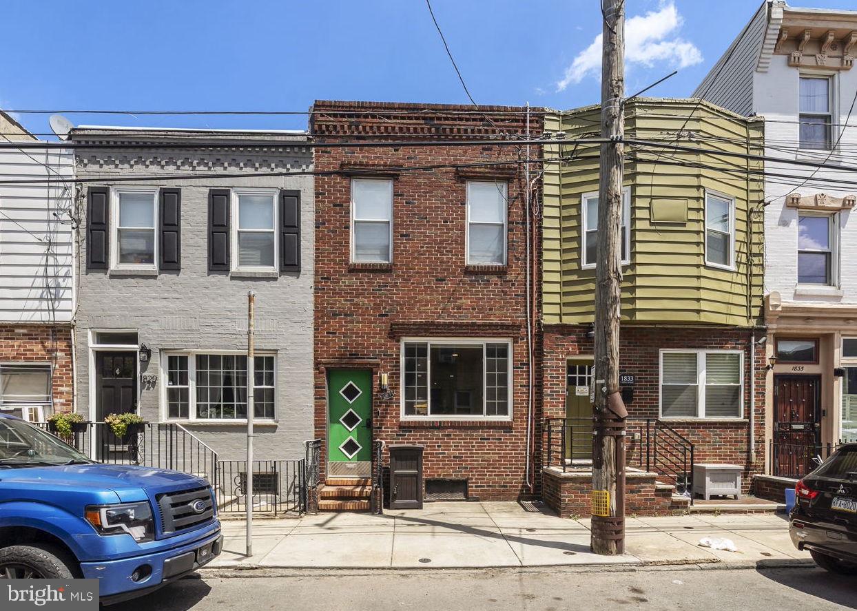 Welcome to your next chapter in one of Philly's most beloved foodie neighborhoods! This charming South Philly row home puts you just steps from the energy of East Passyunk Avenue — and the home itself has plenty to offer, too. Step inside to a bright, open living space featuring beautiful exposed brick, giving the main floor that classic-meets-character look. A convenient half bath on the first floor makes life easy for guests and everyday living alike. Also take note of the solid hardwood floors that can be found throughout the home. A rarity in a world of LVP! In a traditional row home, you’ll always find that there’s one space on the first floor that is smaller than you’d like. Yet somehow, at just under 1200 sq/ft, the living room, dining area, and kitchen are generously sized. Whether it’s fitting that sectional couch you’ve been eyeing, being able to host family and friends with an 8-person dining room table, or finally purchasing that kitchen island that you’ve had in your cart for 2 years, this house will allow your home decor dreams to come true. Upstairs, you'll find three bedrooms. And unlike your average row home, both the front and rear rooms can easily fit a king bed and be treated as the primary bedroom . You’ll also find a newly renovated bathroom with a glass shower and black and white details that will stand the test of time. Head down to the finished basement, ideal for a home office, gym, media room, or extra storage — whatever your lifestyle calls for. The backyard is also not to be missed and will surely become an extension of your living room in the warmer months.  And then there's the location. You're moments from Passyunk Avenue, home to an endless number of independently owned restaurants and shops such as Le Virtu, Ristorante Pesto, Pistolas, Sao, Bok, and more! Grab coffee and a pastry at a neighborhood bakery, browse local boutiques and vintage shops, or just take an evening stroll down one of Philadelphia's only diagonal streets and soak in the energy that makes this neighborhood so special.