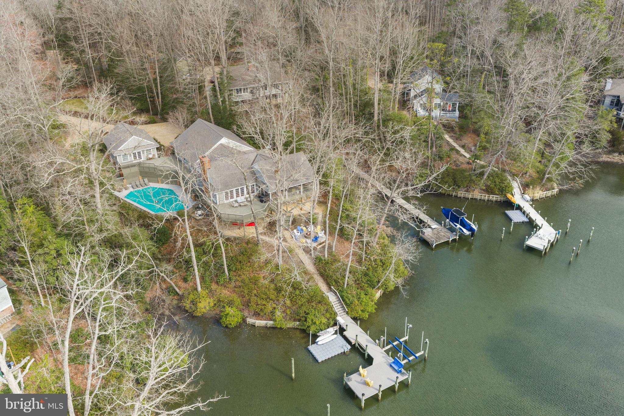 Turn-key waterfront living on Carter’s Creek in the heart of Irvington’s sought-after Glebe Road neighborhood. This 5-bedroom, 4-bath property offers the ideal blend of comfort, entertaining space, and coastal charm, just a short walk or bike ride to Irvington’s shops, restaurants, and amenities. The main level features a stunning great room with vaulted ceilings, exposed beams, and expansive water views, flowing seamlessly onto a large wraparound screened porch and adjoining waterside deck, perfect for indoor-outdoor living. Three bedrooms are located on this level, offering convenient one-floor living. The lower level is designed for fun and flexibility, featuring a spacious rec room with bunk area, full bath, and walk-out access to the pool and waterfront ideal for hosting family and guests. Outside, enjoy a beautifully landscaped waterside setting with a recently replastered gunite pool, fire pit, and multiple seating areas leading to a private pier with boat lift and floating dock on Carter’s Creek. A detached guest house provides additional privacy with a bedroom, full bath, and living area, with a garage located below. Offered fully furnished, this property is completely turn-key ready to enjoy from day one.