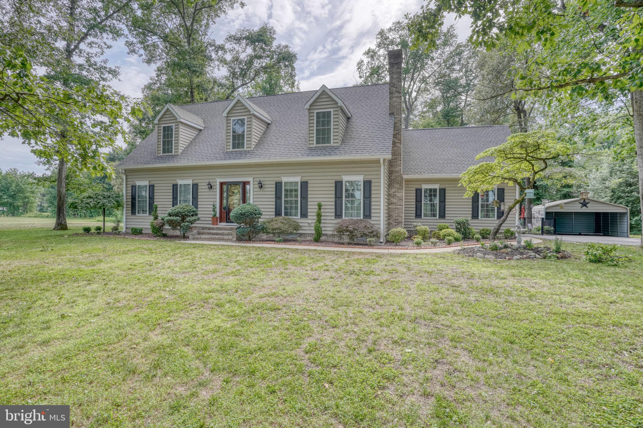 Pristine and spacious paradise ready for its lucky new owners. This sprawling cape cod is completely turnkey. Come down the winding tree lined driveway and enter the new front door to a spacious living area with 9 foot ceilings, family room with fireplace,  new high end LVP floors throughout, large eat in kitchen with custom cabinets and high end appliances and breakfast bar. The primary suite is on the first floor with TWO large closets and a luxe bath. Upstairs is a HUGE additional living area/bonus room  and two huge bedrooms each with their own en-suite baths. There is also a first floor powder room, and two car side entry attached garage. Step out back to a private oasis- a beautiful heated fiberglass pool with a max depth of 5' with fountain running the entire length, custom pavers, large gazebo, and fully finished pool house with HVAC that is currently being used as an office. All pool mechanicals are fully enclosed in a shed. There is also a carport for more storage. Roof and HVAC systems have both been recently replaced. There is also a whole house generator- so no fears of winter power outages here. Every inch of the property has been lovingly maintained by the current owners- there is nothing left to do but move in. All of this located on a full acre with lots of mature trees for privacy. Easy travel on route 13 to points north or south- get to Dover Air Force Base in 20 minutes and Delaware beaches in 25 minutes! Now scheduling private tours.