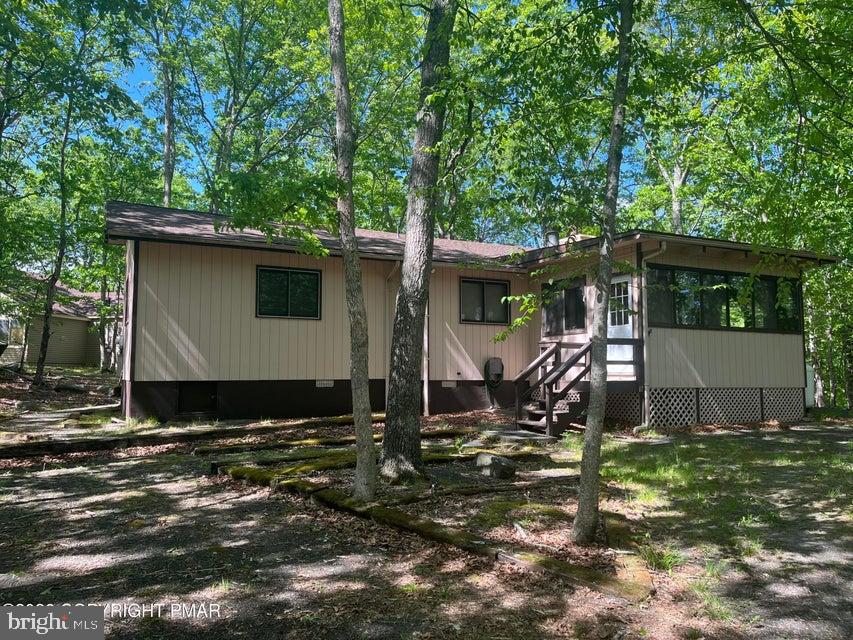 You have found all that you could want in a weekend getaway or full time residence. This 3 bedroom 2 bath ranch offers complete privacy from the road and a spacious warm interior once you are inside. Sitting on the giant deck and screened in porch you will feel like you are on top of the world and one with nature. The inside features a family sized great room, 3 giant bedrooms and 2 ample sized bathrooms. The tongue and groove vaulted ceiling gives the interior added warmth and mountain charm. The sun room features a wood burning stove that will keep the inside toasty on the coldest days. The updated kitchen features stainless steel appliances. The owners also have recently replaced the roof and redone the deck. Come see the mountain beauty--it will not disappoint!!