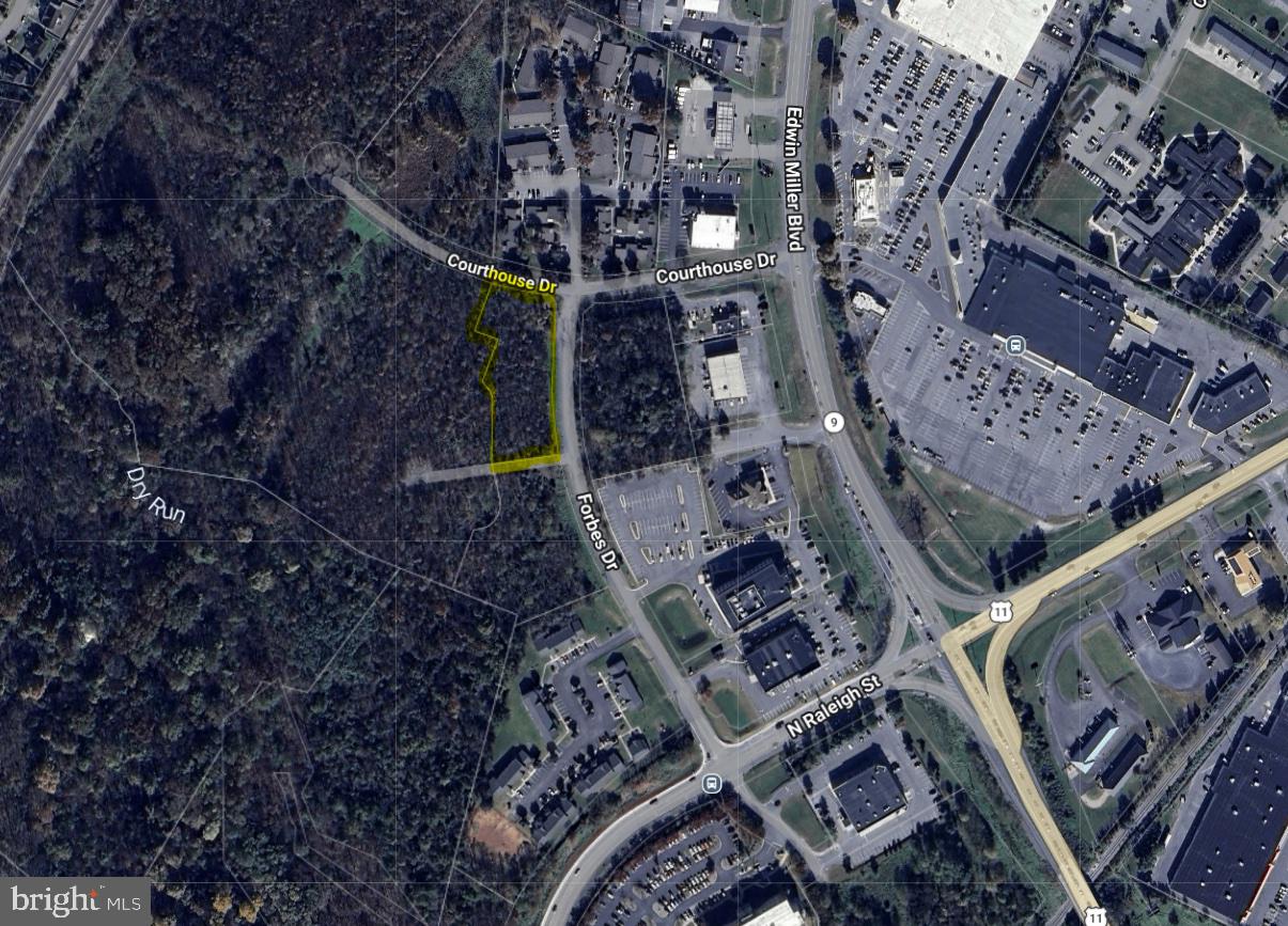 Looking for a  commercial opportunity in the fast-growing, high-density, north end of Martinsburg, but can't stomach the prices of the other options? This 1.8 acre property (Tract A), zoned Mixed-Use Commercial (MUC), offers the possibility to get into this space for around half the price of many of the other currently available options. Permitted uses include general retail, convenience stores, food & beverage, group residential housing, hotels, government facilities, multi-family dwellings, schools, AND MANY OTHERS - see View Docs for the Zoning Ordinance. This property fronts over 300' on Forbes Dr (paved) and backs DIRECTLY up to DRB Homes' 170+/- townhome community known as The Villages at Courthouse Square. Access to this property from Edwin MIller Boulevard would be via the Edwin Miller Blvd and Raleigh St extension intersection (which already has a stoplight) or the Edwin Miller Blvd and Courthouse Dr intersection (which is soon getting a stoplight). An adjacent tract (1.8 Acre Tract A), which also fronts 300'+ on Forbes Dr, and also backs DIRECTLY up to DRB Homes' townhome community, is also available for purchase for $375,000.