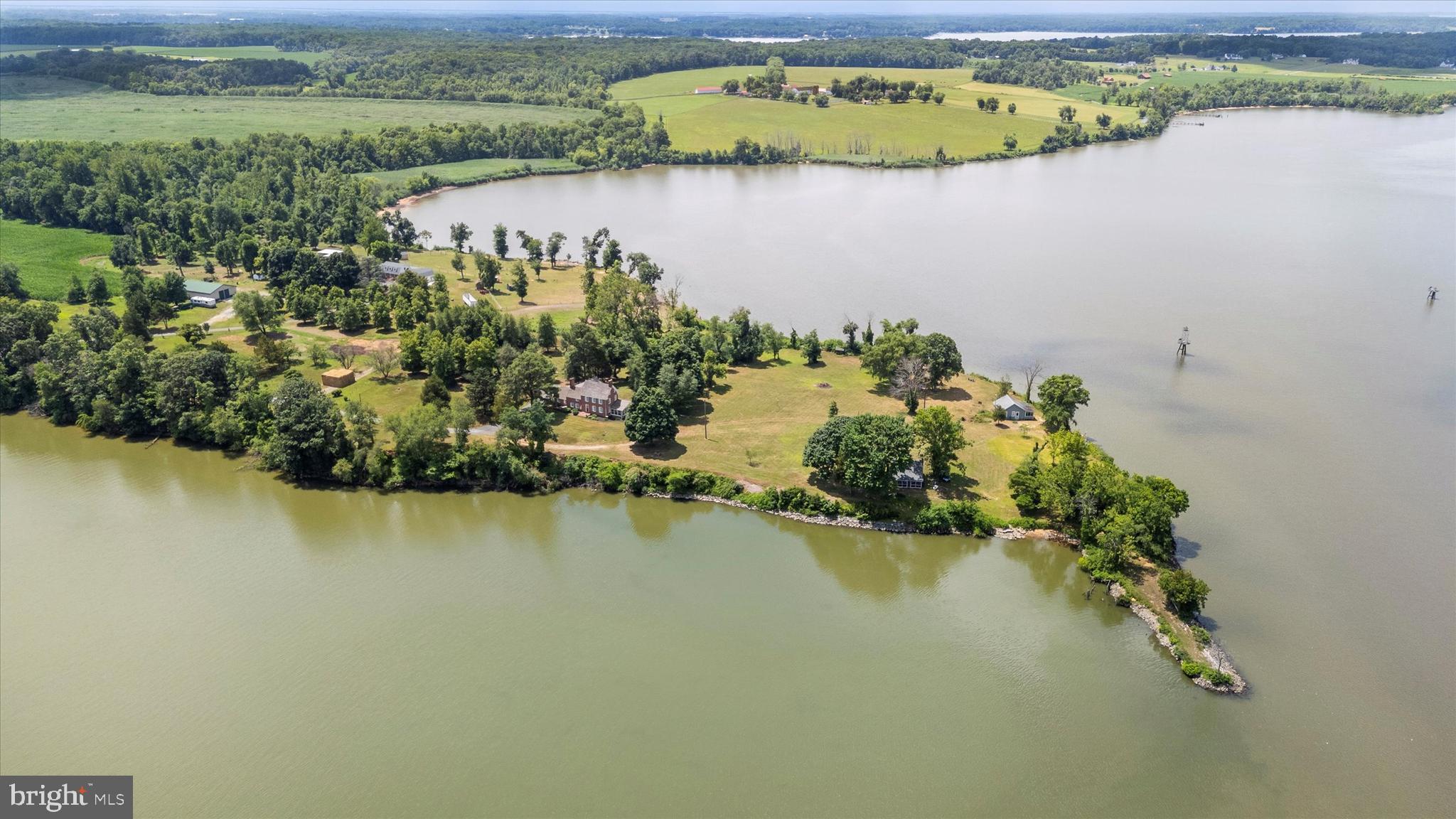 Price Improvement!! Welcome to your own exclusive waterfront Eastern Shore paradise at Court House Point. This unique property is nestled along the banks of the Elk River in Chesapeake City, Maryland. This historical site, once home to the Cecil County Court House, provides a unique glimpse into the past. Imagine British ships sailing up the Elk River as you stand on this scenic projection.
Court House Point was the site of the second county seat from 1719 to 1782, also serving as the terminal of the Elk Ferry. This exceptional property boasts nearly 2,400 feet of shoreline along the Elk River and the Intracoastal Waterway, offering views of ships from around the world navigating the third busiest canal globally.
Spanning approximately 8 acres, the property features a nearly 4,000 square foot Federal Style home that includes the old Court House. Additionally, there are two smaller cottages along the waterfront—one fully restored, the other awaiting restoration. Historically, a dock (Wharf) was present on the property. The main home has been modernized while retaining much of its historical charm and character.
The home comprises two bedrooms, two baths, an attached two-car garage, and a walk-up third-floor attic. With its very private setting and 8-acre expanse, this is your own personal paradise. The shoreline is protected with Rip Rap.
Come and experience the unique charm and historical wonder of Court House Point! This type of property only comes along once in a lifetime.