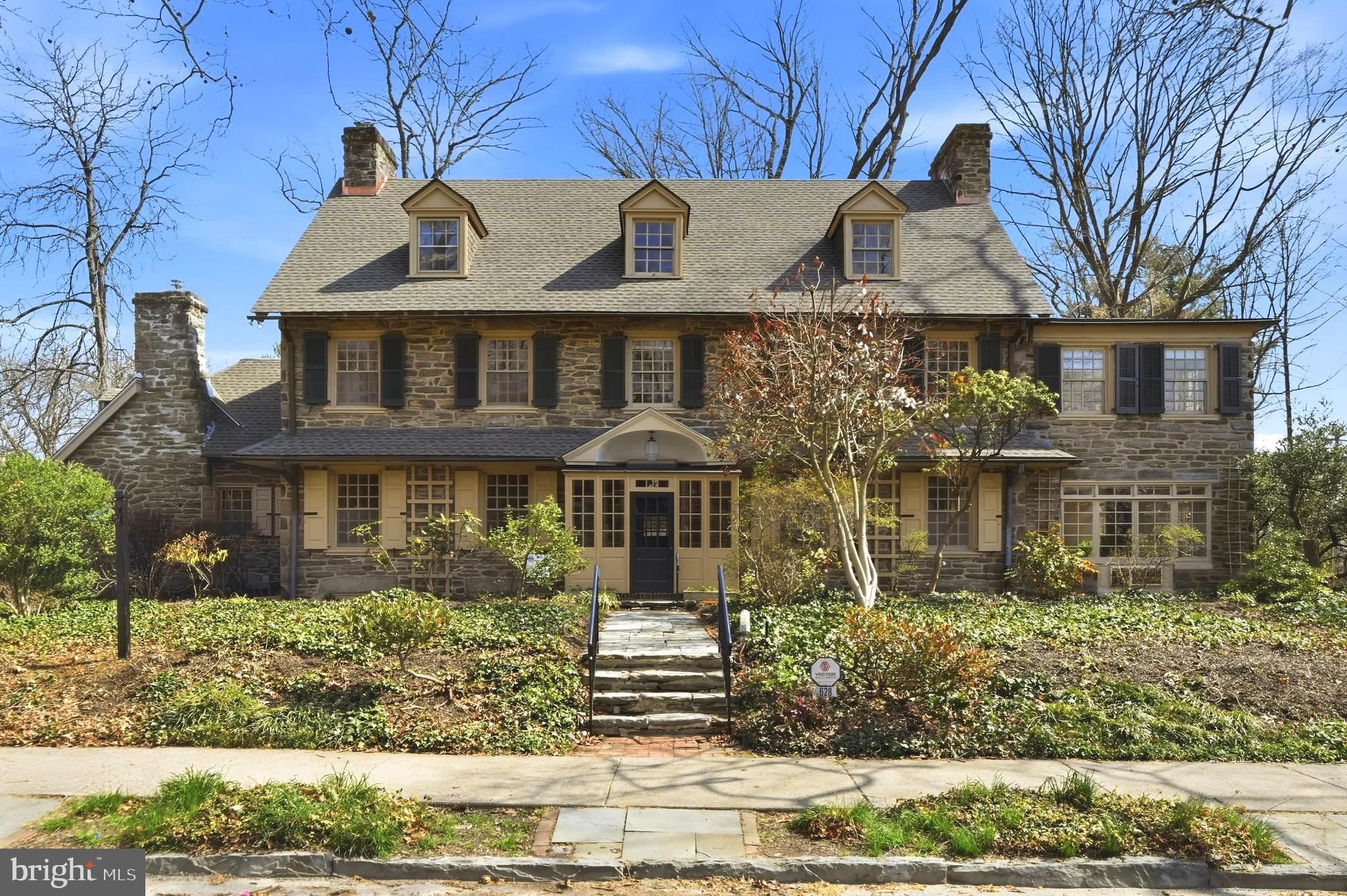 Step into timeless elegance with this exquisite Wissahickon stone center-hall colonial, an architectural masterpiece crafted in 1910 by the renowned Philadelphia firm of Duhring, Okie & Ziegler. Nestled on 1.2 acres of picturesque grounds, this 5,570 sq. ft. residence is a harmonious blend of historic charm and modern comfort, boasting 5 bedrooms, 4.5 bathrooms, and no fewer than 5 fireplaces—4 wood-burning and 1 gas-fired. The sale includes the adjoining parcel at 6523 Wissahickon Ave. tax id # 223280420. Lot dimensions, assessments and taxes are both parcels combined.

As you enter through the Dutch front door, you'll see a grand central hall with gleaming refinished oak floors, intricate wainscoting, high ceilings, and a formal staircase that exudes sophistication. Fluted casings frame the entryways, inviting you into the heart of the home. To the right, the expansive living room (27' x 17') enchants with picture-frame molding, a marble-framed fireplace, and French doors that lead to an all-season sunroom. Here, you’ll find built-in cabinetry, gravel beds for greenery, and its own cozy fireplace. The sunroom extends, through sliding glass doors, to a flagstone terrace, the perfect backdrop for outdoor entertaining or serene moments overlooking the wooded lot.

To the left of the hall lies a formal dining room (20' x 17') with a striking granite-framed fireplace, a brass chandelier, and a wood-carved mantel that whispers of craftsmanship from a bygone era.  Adjacent is a butler’s pantry, a charming powder room with a barrel ceiling, and a thoughtfully designed eat-in kitchen (15' x 15'). The kitchen features granite countertops, a functional work island, stainless steel appliances, including a new gas range with a convection oven , and a window seat offering tranquil backyard views through a lovely triptych window.  A nearby mudroom with a Palladian window and abundant storage adds practicality to the home’s graceful design.

Ascend to the second floor, where French doors open to a light-filled study, or art studio (16' x 9'), with exposed beams and panoramic views of the lush rear yard. This level offers two spacious bedrooms, each with its own bath, and one with a wood-burning fireplace. The pièce de résistance is the luxurious primary suite, complete with its own library or home office (17' x 17') featuring built-in bookshelves and a gas fireplace. The suite also includes a grand bedroom (23' x 14'), a dressing room, and a spa-like tiled bathroom with a large stall shower. The third floor offers two additional bedrooms (20' x 15') and a shared hall bath, perfect for guests or family.

The property’s outdoor amenities are equally impressive. Beyond the stone parking area and charming wooden gate lies a private retreat: an in-ground swimming pool and a heated pool house. Formerly a garage, the pool house features a flagstone floor, a hot tub, a cedar-lined sauna, and a full bathroom. Upstairs, a one-bedroom apartment with a living room, kitchenette, and bath provides a private haven for guests or extended family. A boardwalk meanders through the adjacent & included wooded lot, leading to a tranquil seating area ideal for birdwatching or meditation. The woods have a variety of beautiful native wild flowers.

Designed by a firm celebrated for their "comfortable, homelike qualities," this historic home offers a rare opportunity to own a piece of architectural heritage while enjoying the luxuries of modern living. This is more than a house—it's a lifestyle of elegance, warmth, and timeless beauty, located in West Mt Airy, minutes to Fairmount Park, Rt 76,  and Center City.