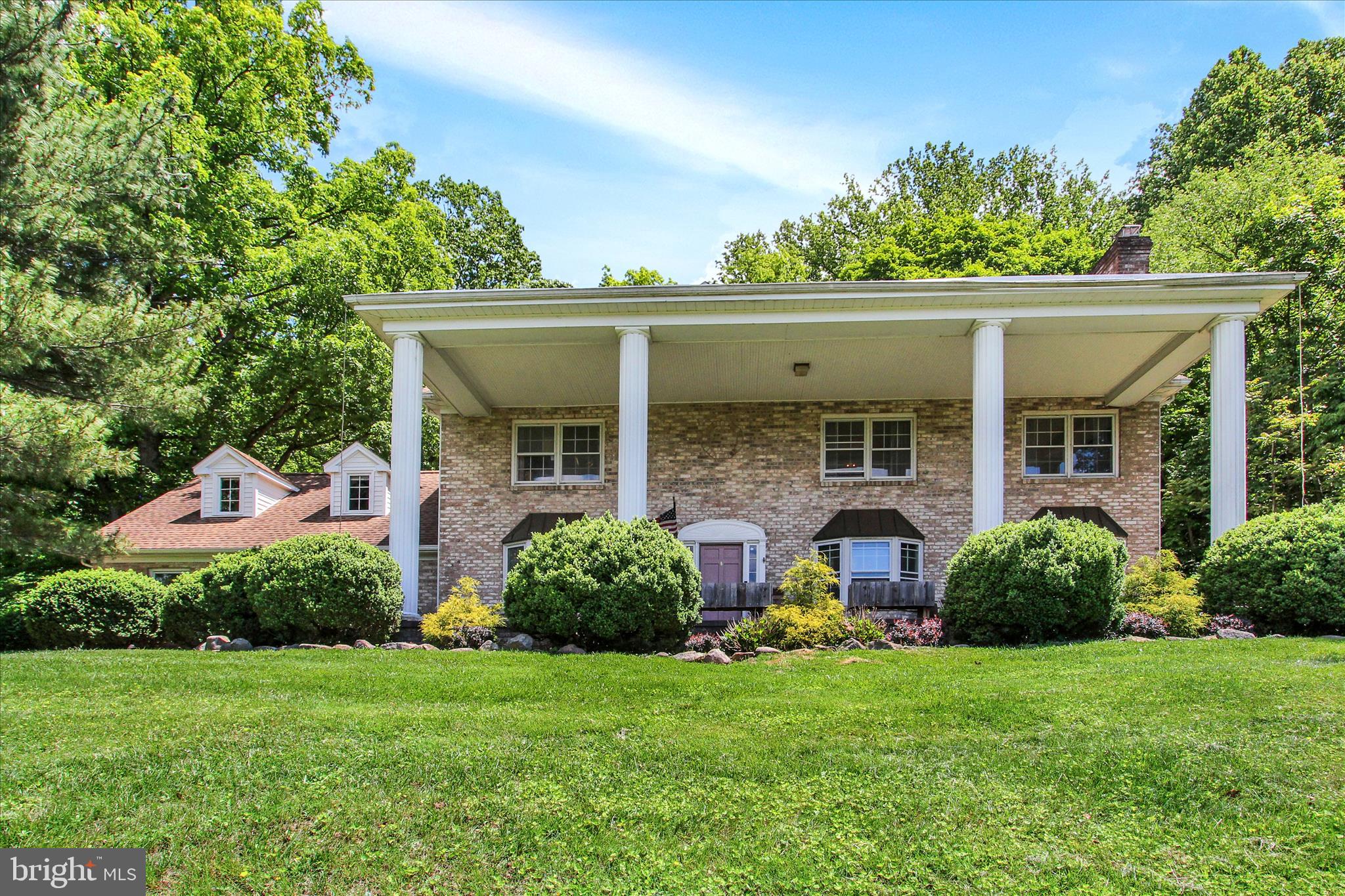Take in the breathtaking view from the huge front porch of this 5368 sq. ft., 7 bedroom, 7 full bath, with in-law apt/air BNB apt, Georgian Colonial brick home on .9 acre partially-wooded private lot, just a short walk to Carroll Valley Golf Course and Liberty Mountain Ski Resort and a short ride to the Maryland border and historic Gettysburg.   Current owner remodeled in-law studio apartment with kitchenette, bath, dining and bedroom as an AIR BNB (zoning requires owner using house as primary residence). Every room in this elegant house is stately-sized.  First and second level floors are gorgeous hardwood and ceramic tile.  Some recent upgrades include $28,000 upgraded 8-zone propane tankless boiler and tankless water heater, along with new 3rd floor air conditioning unit (Total of 4 air conditioning zones).  Eat-in kitchen is updated with quartz counter tops, tile floor and tile backsplash, island and pantry cupboard.  6 of the 7 total bathrooms have been updated within the last couple years.  Sale includes hot tub, cedar sauna in lower level bath, 6 theatre chairs along with projector and screen, and all Air BNB furniture.  Too many features to list!