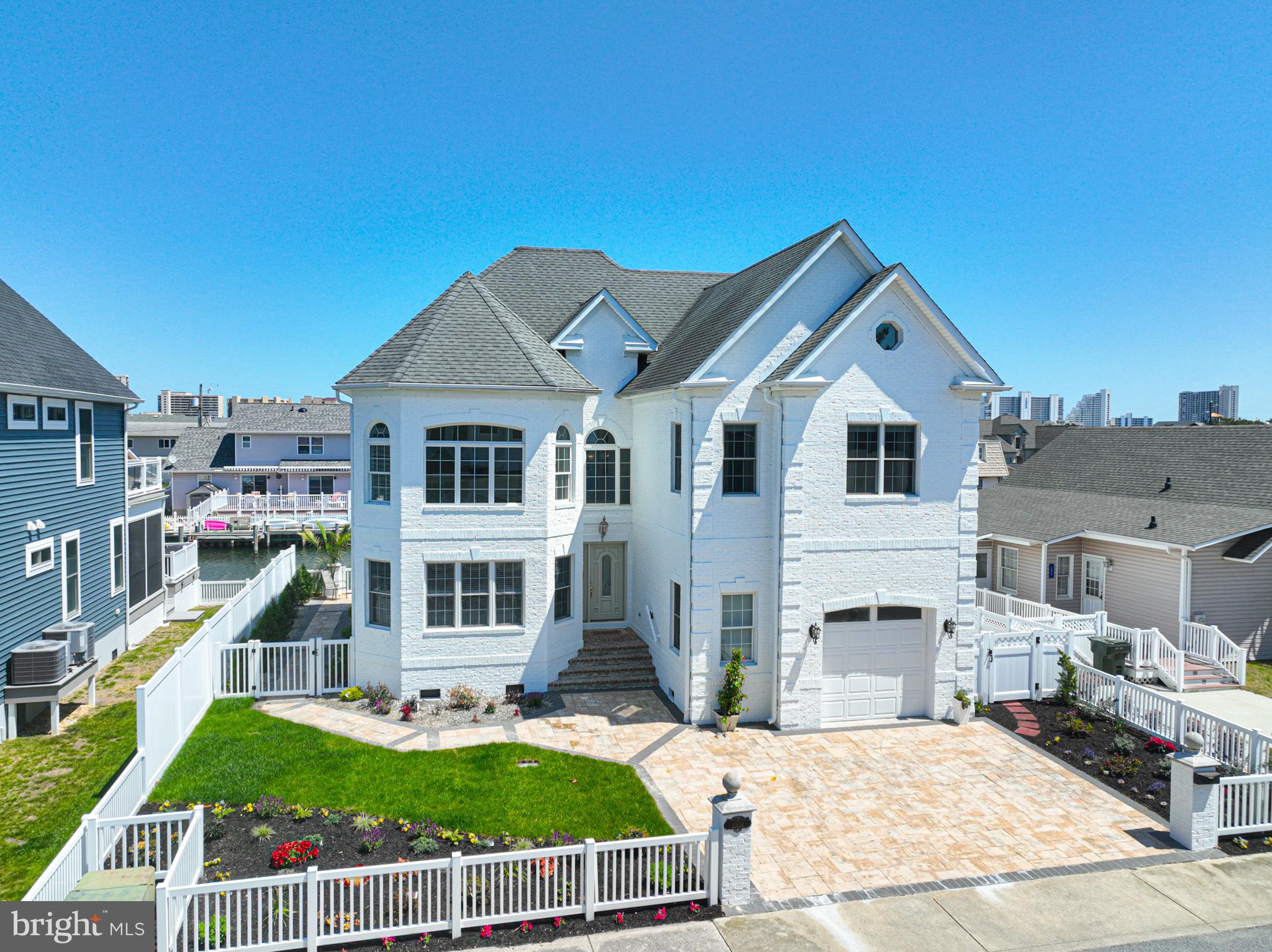 Experience elevated coastal living in this stunning luxury waterfront retreat in Ocean City. Offering 4 spacious bedrooms and 4.5 beautifully designed bathrooms, this recently updated home blends modern elegance with relaxed beachside charm. Soaring vaulted ceilings create an open, airy feel, while expansive living areas and oversized bedrooms provide comfort and flexibility for both everyday living and entertaining.
      The gourmet kitchen and spa-inspired bathrooms showcase high-end finishes and thoughtful design throughout. Step outside to your private tropical oasis—complete with lush landscaping, full irrigation and drip systems, a stylish pergola, and a relaxing hot tub surrounded by vibrant greenery—perfect for unwinding after a day on the water.
     Boating enthusiasts will appreciate direct access to both the Atlantic Ocean and the scenic Assawoman Bay, along with two PWC lifts and a full powerboat lift, making waterfront living effortless. An attached garage adds convenience and additional storage.
     Located just minutes from Ocean City’s renowned nightlife, dining, and year-round entertainment, you’ll enjoy everything from waterfront restaurants and live music to festivals and events that make this coastal destination so vibrant.
     Whether you're seeking a luxurious primary residence, vacation escape, or investment opportunity, this exceptional waterfront home delivers the very best of beach living.