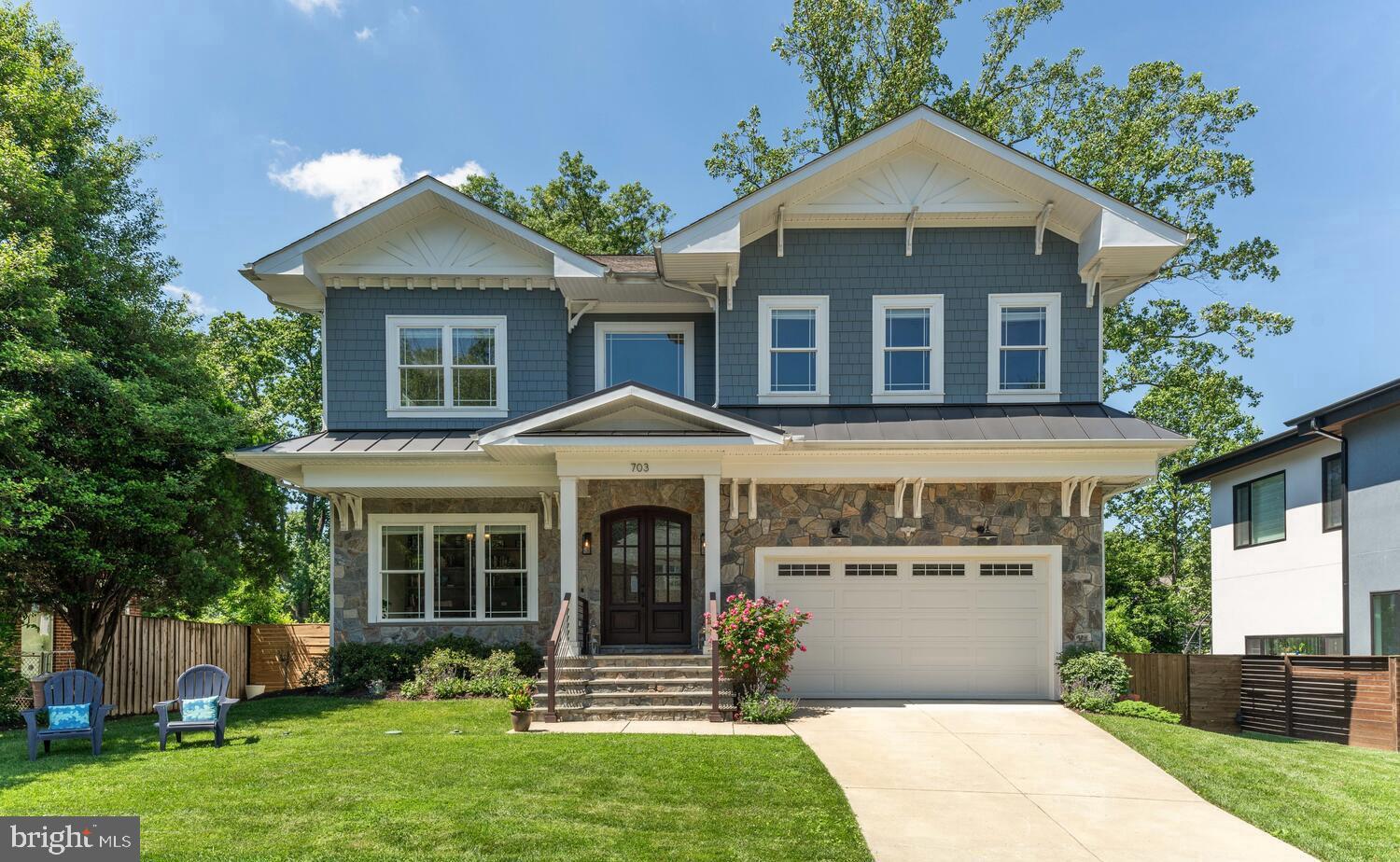 Welcome to 703 Ware St SW!  Built by AR Design Group and with interior design by Hallstrom & Associates, this picture perfect 5-bedroom craftsman style home has everything you could ask for.  Located just a block from Meadow Lane Park, a fabulous community park offering a large playground, tennis courts, basketball court, playing field and picnic pavilion. This home is also just a few blocks from Maple Avenue where one can find many restaurants, shops, the library and Town Center. Vienna Community Center and Waters Field are also easily accessible from this location. Easy access to route 66 and Vienna Metro Station (1.7mi away).
 
The handsome exterior architecture of this home features double mahogany entry doors, beautiful stone façade, marine blue hardie plank siding with white trim and gorgeous architectural corbels which accentuate the upper level. With wonderful curb appeal the home greets you with a pretty front lawn, slate porch and two-car garage.  The fully fenced lot also offers a large, flat, backyard with gorgeous trees and privacy. Relax or entertain on the trex deck located just off the family room and kitchen.
 
Constructed just 5 years ago, the custom level of design done by the builder/interior design firm becomes readily apparent once you walk inside.  The spacious foyer with 4-piece crown moldings leads to the library with French doors and built-ins. A formal living room opens to a light filled dining room with tray ceiling and rope lighting.  The expansive kitchen has 10’ ceilings, a large quartz island with plenty of seating space, black granite countertops, stainless steel appliances, gas cooking and beautiful cabinetry with lighting. The kitchen area also has a large breakfast area with built-in bench seating. The large walk-in pantry, walk-in mudroom/closet and access to the 2-car garage are just off this room. Beyond the kitchen is a spacious family room with window bench seating (with storage) and an elegant gas fireplace and mantle. Throughout the main level, the high ceilings, extensive crown molding, and customized architectural elements add to the beauty of this very spacious and functional floor plan.
 
The upper level features a very large primary bedroom suite with two expansive walk-in closets with built-ins, a primary bathroom with double vanities, a vessel tub and a large walk-in glass shower with rain head and bench seating.  In addition, the upper level offers 3 more spacious bedrooms with ensuite bathrooms and walk-in closets with custom built-ins.
 
The light-filled lower level has many windows with views of the rear lawn, along with double French door access to the yard from the secondary family room and 9' ceilings.  This room also features a wet bar area with island and bar seating.  This lower level also offers a theater room with handsome wall sconces, an office/playroom and a bedroom with full-bath.
 
Truly, this home is a rare find with outstanding quality of construction and design, a fabulous floor plan and an amazing location in the heart of Vienna. Welcome Home!
