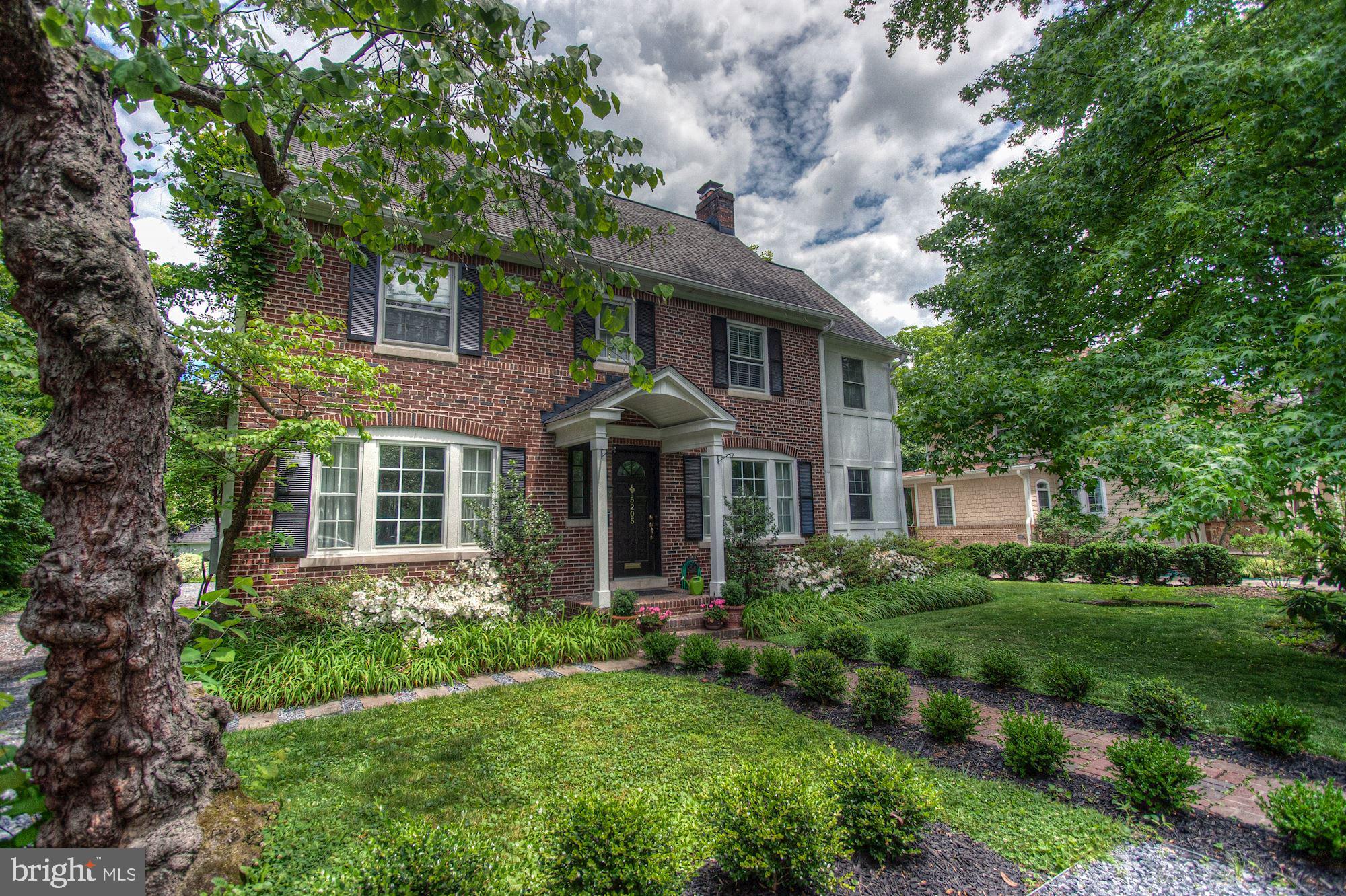 **NEWLY PRICED**Presenting one of Bethesda’s Grand Dame colonials, with nearly 100 years of character complemented by modernized infrastructure.  Originally finished in 1923, this stately colonial is a classic example of period colonial architecture. With nearly 4,500 square feet on 4 finished levels with two re-lined wood-burning fireplaces, the spaces provided by this attractive floor-plan will delight every member of the household. Traversing the symmetrically landscaped brick walkway through the front entry, you are drawn into the formal living room featuring a wood-burning fireplace to your right, on the left is the formal dining room. Adjacent to the living room is a natural light-drenched sunroom, and the main level is completed with an expansive added-on gourmet kitchen with radiant heated floors that will serve as the heart of this home. There is a pantry, butler’s pantry area, powder room and laundry area just off of the main kitchen.

Up the stairs from the main level is the primary bedroom floor, showcasing the owner’s suite with vaulted ceilings and dual walk-in closets. A 5-piece luxury owner’s bath with radiant heated floors complete this space. Three additional bedrooms, plus a handsome bonus room (converted from an earlier sleeping porch) with another wood burning fireplace. On the finished loft level (3rd floor) is another bedroom with lounge area, and a playroom that can be used as another bedroom space.

The lower level offers ample room for entertaining, and extensive storage options as well. The rear grounds offer plenty of space for the active, and a raised rear-deck provides a perfect venue for al fresco dining. The parking courts offer space for numerous vehicles for residents and guests, and the public transportation options of downtown Bethesda are just minutes away. As mentioned above, there is a sense of community throughout the neighborhood. Parades on symbolic national holidays, halloween gatherings, cookouts and celebrations are regular occurrences. You will love living here.

The neighborhood, Battery Park, is a close-knit community surrounded by nature.Originally developed by a contingent of World War I veterans, whom all served in the same artillery battery (hence the name), the area grew popular with the public at large who were drawn to this magnificent residential neighborhood for all the reasons described above. The first three houses completed in the neighborhood were 5203 Wilson Lane, 5207 Wilson, and the property that has drawn your eyes to this page: 5205 Wilson Lane.