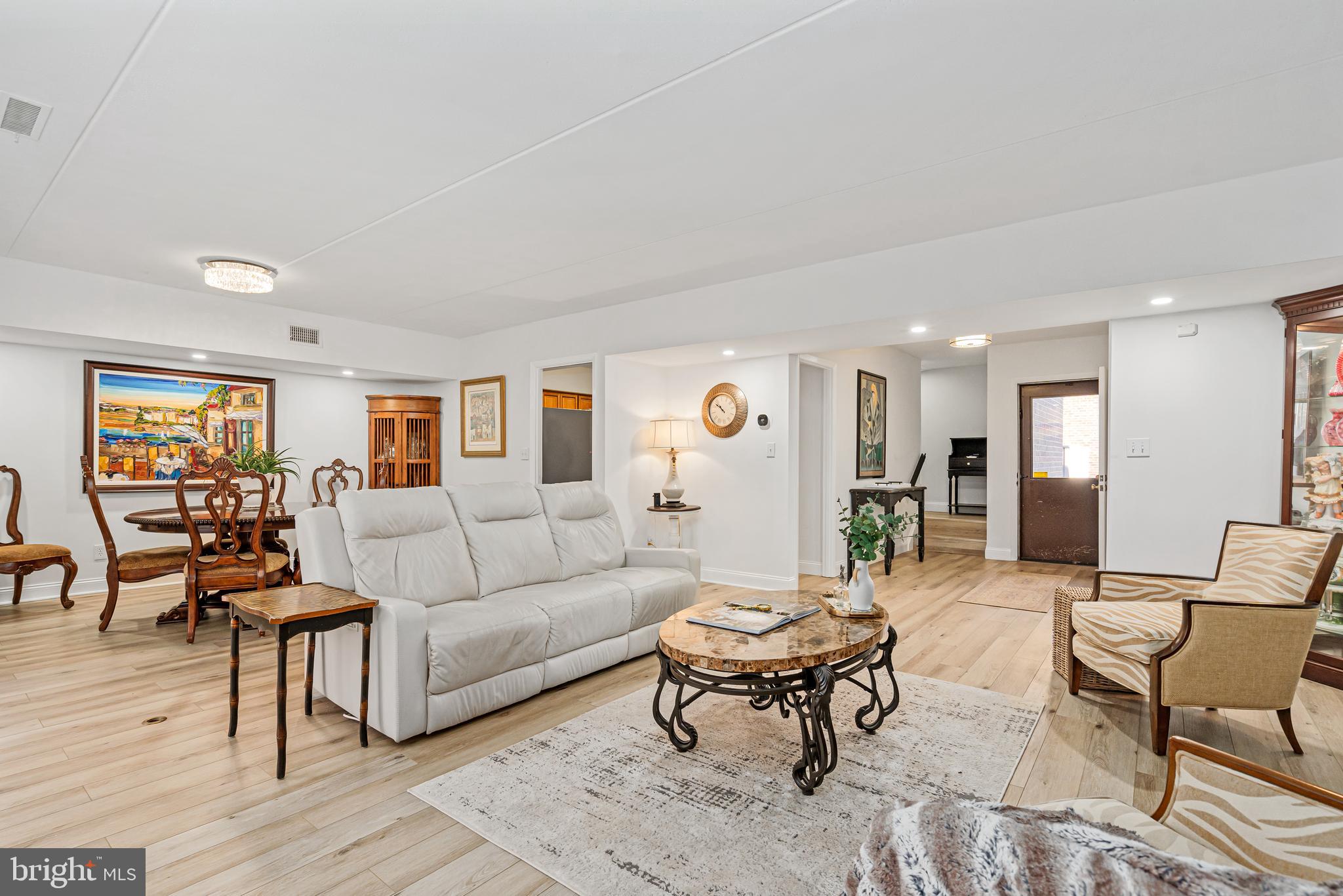 Welcome to this beautifully updated townhome in the sought-after Annen Woods community! As you enter, you're greeted by an open foyer and elegant LVP flooring that flows throughout the home. The open living and dining room is the ideal space for hosting dinner parties and gatherings with family and friends. Cozy up in front of the charming brick fireplace on cooler evenings. The eat-in kitchen is a chef's dream, offering an abundance of cabinet space, granite countertops, stainless steel appliances, and a pantry for all your storage needs. The conveniently located laundry area adds extra functionality. Adjacent to the kitchen is the family room, featuring a large sliding door that opens to the front yard, creating a bright and inviting atmosphere. Upstairs, the spacious primary suite is a serene retreat, complete with a large walk-in closet and a luxurious en-suite bathroom. The primary bath boasts dual granite vanities, ceramic tile floors, a separate shower room, and plenty of space to unwind. An additional bedroom provides the perfect space for guests or a home office, while a second full bathroom with dual vanities and a tub/shower combo ensures convenience for everyone. Step outside to the back deck off the living room, perfect for entertaining or simply relaxing in a peaceful setting. Annen Woods offers the ultimate in community amenities, including a pool, tennis courts, and a playground, all within the privacy of a gated neighborhood. Conveniently located near Reisterstown Road, Park Heights Avenue, 695, and a variety of shops and restaurants, this home offers both comfort and convenience. Don’t miss your chance to call this wonderful property home—schedule your showing today!