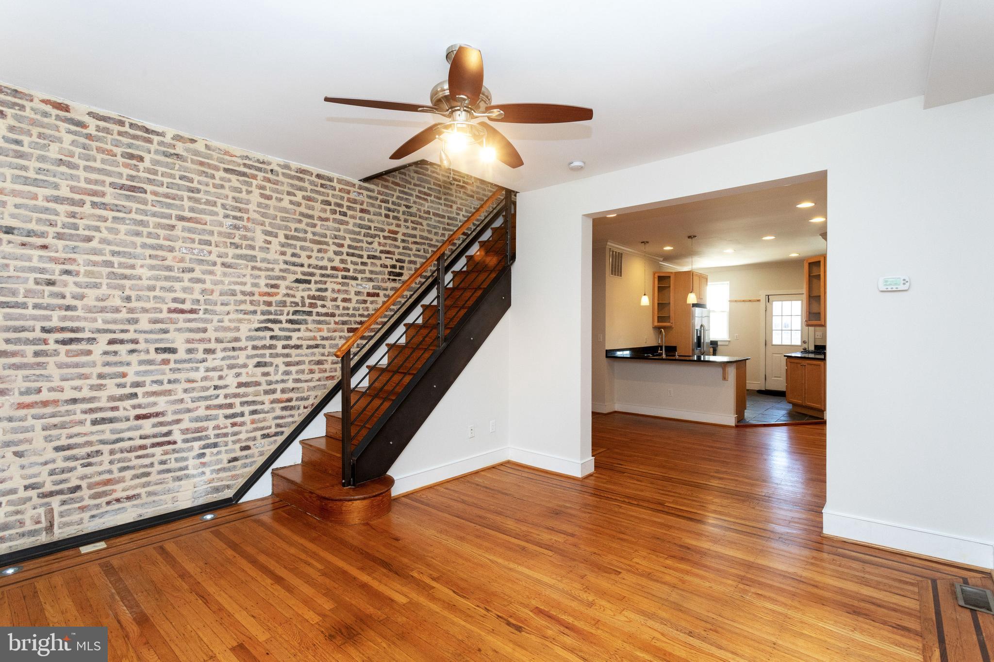 Beautiful renovation offers pleasing combination of original details (inlaid floors, exposed brick) and modern conveniences (finished lower level, fabulous kitchen and bath), all steps from shops, restaurants and Riverside Park. The second floor has an open floor plan; the primary bedroom has no door and is open to dressing area/office space. There is a smaller bedroom/office behind french doors at the top of the stairs outside of which is  the dressing area/office space and hallway primary bedroom.   The large double shower head 2nd floor bath  is a definite WOW!  The bright and cheery finished lower level features a full bath, laundry and exterior access.  Parking pad in the rear.  Ready for immediate occupancy for minimum of 1 year and maximum of 5 year lease.   OWNER PAYS OIL AND WATER.  LONG TERM LEASES WELCOME.