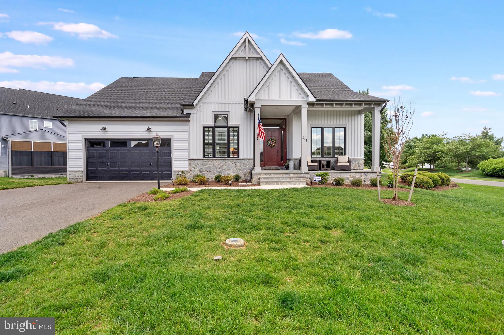 Welcome to this stunning award-winning Farmhouse Collection 2025 ranch style home located in the sought-after gated community of Bellair. This beautifully designed  home combines luxury finishes, thoughtful upgrades, and easy main-level living with an exceptional open-concept floor plan. From the moment you enter, you will appreciate the soaring ceilings, luxury vinyl plank flooring, and bright, welcoming foyer. A dedicated office with recessed lighting and LVP flooring provides the perfect work-from-home space. Beautiful plantation shutters installed throughout the home add timeless style and elegance. The gourmet kitchen is truly the heart of the home, featuring gorgeous marble countertops, a massive center island, farmhouse sink, stainless steel appliances, wall oven, gas cooking, and abundant cabinet space. The adjoining dining area showcases spectacular oversized sliding glass doors that flood the home with natural light and create seamless indoor-outdoor living. Step outside to enjoy the screened-in porch with Trex flooring and recessed lighting, which opens to a brand-new Trex deck with vinyl railings and steps leading to the backyard. The spacious living room offers a gas fireplace flanked by custom built-ins with marble tops and opens beautifully to the kitchen and dining areas, making this home ideal for entertaining. The luxurious primary suite features an impressive custom-organized walk-in closet with extensive shelving and a spa-like primary bath with a marble double vanity, luxury vinyl tile flooring, and a walk-in shower. A secondary main-level bedroom includes carpet and its own private en-suite bath with beautiful ceramic tile flooring and a tiled tub shower. The finished lower level offers even more living space with a huge rec room, an additional carpeted bedroom, and another full en-suite bath with ceramic tile flooring and a tub-shower combination. There is also a large storage room complete with a passive radon system, sump pump, and water softener. Additional highlights include a two-car front-load garage, Hardi Plank siding, stone water table, and a gorgeous covered front porch. Residents of Bellair enjoy outstanding community amenities including a pool, walking trails, and HOA-maintained lawn care with mowing, mulching, and weeding included for low-maintenance living. Tucked away for peaceful everyday living, yet perfectly situated for commuters traveling to Maryland, Virginia, or Washington, D.C.