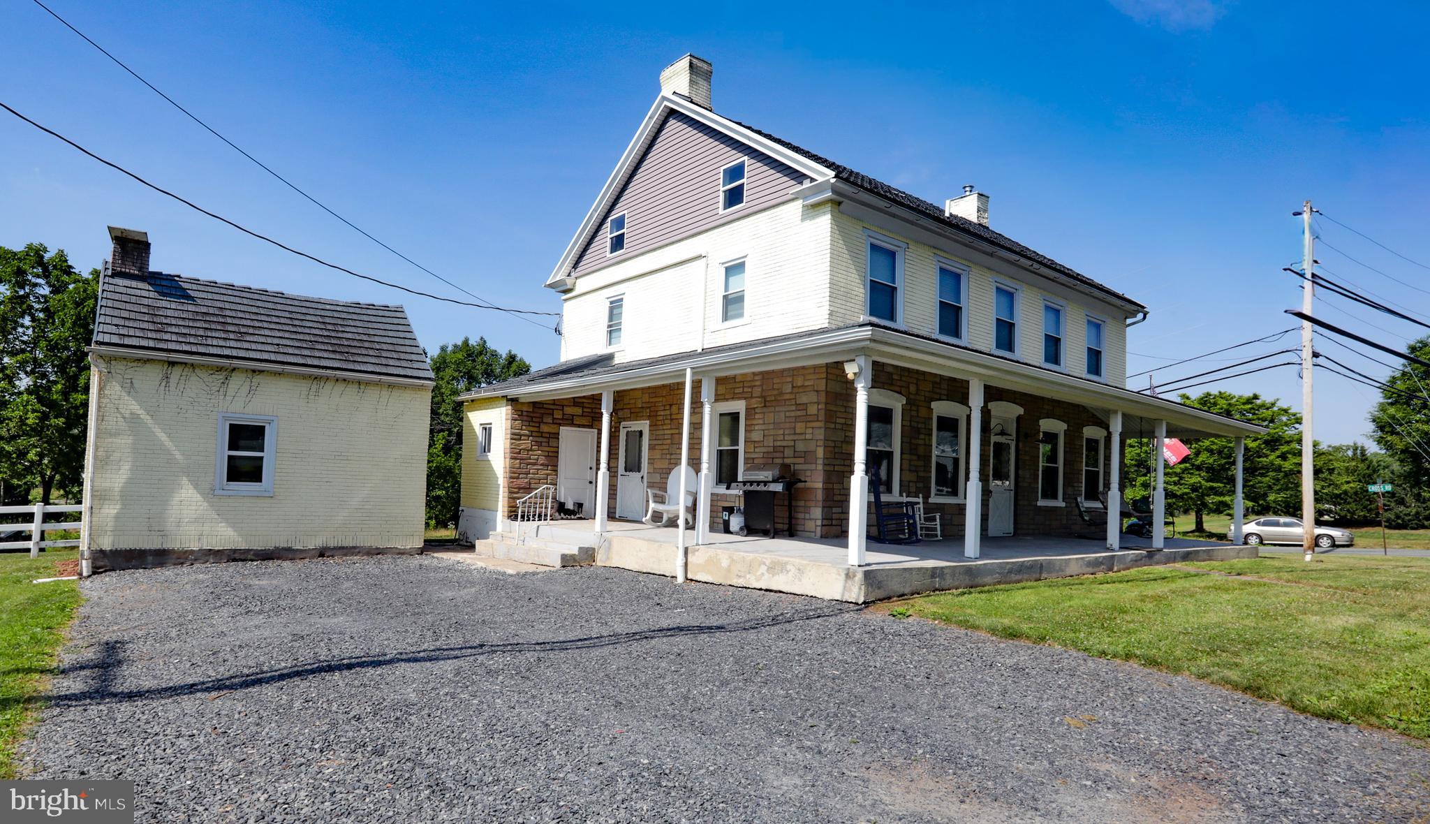 Timeless farmhouse charm meets modern luxury in this beautifully renovated 2 1/2 story home, with detached 2 car garage and smokehouse.  Every detail has been thoughtfully updated while preserving the character that makes this property truly special. Offering 4 bedrooms and 2.5 baths, this 2900 sq. ft. home features wide-plank flooring throughout, deep windowsills, and an inviting living room highlighted by an exposed brick accent wall. The spacious first floor is designed for both everyday living and entertaining, with a large kitchen featuring an island with seating for three, an open dining area, and a multi-zone sound system that creates the perfect atmosphere throughout the main level.  The second-floor primary suite is  complete with a spacious walk-through closet leading to a beautifully appointed en-suite bathroom featuring a double-bowl vanity, heated tile floors, and a custom tiled shower with a luxurious rain showerhead. Two additional bedrooms of which one is currently a home office and a full hall bath complete the second floor. The finished third floor offers a versatile fourth bedroom with the potential to create a fifth bedroom; It is currently configured as a spacious storage area, providing flexibility to suit your needs.  The full unfinished basement with outside exit provides abundant storage, a dedicated mechanical room, and even showcases the original fireplace opening—a charming reminder of the home's history.  This property has been extensively upgraded, including updated electrical wiring and lighting throughout, smart light switches, smart HVAC controls, eight mini-split systems for efficient climate control, newer appliances, one-year-old heating system and well pump, two-year-old water filtration system. This exceptional farmhouse with a wraparound porch seamlessly blends historic character with today's modern conveniences, offering a move-in-ready home that is as functional as it is beautiful.  Located in Boyertown Schools with 1 minute access to Rt 100.  Don't miss the opportunity to make this one-of-a-kind property your own.