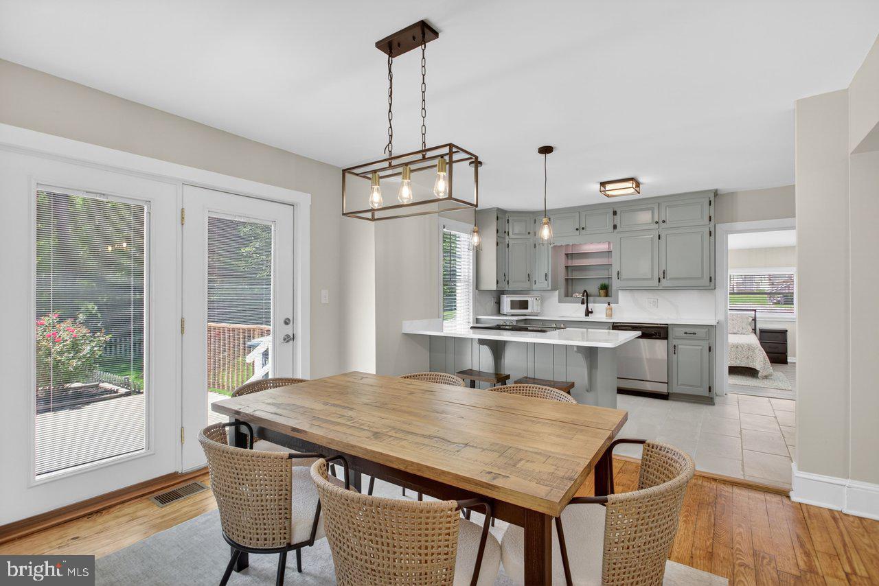 Nestled in the heart of Harrisonburg, this beautifully updated 4-bedroom, 2-bathroom home blends modern comfort with timeless character. From the moment you step inside, you’ll notice the natural light, easy flow, and original flooring that adds warmth and charm throughout much of the home.

The thoughtfully reimagined kitchen combines preserved original cabinetry with custom additions, creating a beautiful and functional space. The inviting color palette pairs perfectly with the new quartz countertops and backsplash. An open layout between the kitchen, dining room, and living room creates an ideal setting for everyday living and entertaining.

The main level offers two spacious bedrooms, including one with a walk-in closet, along with a generously sized updated bathroom. The rear bedroom provides wonderful flexibility and could easily serve as an additional family room, office, or guest space. Classic architectural details throughout the home create a warm and welcoming atmosphere.

Upstairs, you’ll find two additional bedrooms, ample closet space, and a brand-new full bathroom. The unfinished lower level offers excellent storage, workshop potential, or future possibilities.

Outside, the home offers a rare in-town retreat with a large, fully fenced backyard on a quarter-acre lot. Whether you’re entertaining, gardening, enjoying space for pets, or simply relaxing outdoors, this private setting offers exceptional versatility. Properties with this much outdoor space in such a central location are hard to find.

Recent updates include almost all new windows, a mini-split HVAC system, a replaced heat pump, updated bathrooms, kitchen improvements, and much more.

Conveniently located just a few blocks from downtown Harrisonburg, you’ll enjoy easy access to restaurants, local shops, coffee spots, entertainment, community events, parks, walking trails, and recreation. The home is also close to JMU, making it an excellent option for an owner-occupant, rental investment, student housing, faculty/staff housing, or a special in-town residence.

Don’t miss this unique opportunity to own a beautifully updated home with historic charm, modern amenities, exceptional outdoor space, and an unbeatable Harrisonburg location.

UPGRADES AND UPDATES INCLUDE:
New windows
New chimney liner
AC coil and outside unit
New mini-split system for upstairs
Refinish floors
Open kitchen, refinish cabinets
New counters
New refrigerator 
New tile in the kitchen and bathrooms
Added a new second bathroom
New bathroom vanities and toilets
Drywall ceiling and lights in back room
New light fixtures throughout
Upgrade electrical to 200 amp
All new outlets
Interior paint
