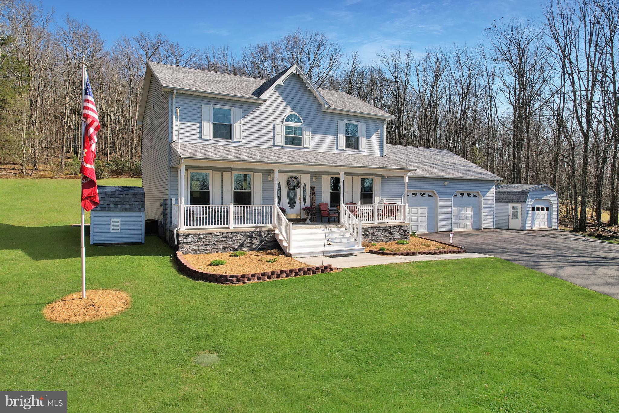 Welcome home to peace, privacy, and mountain living at its finest in desirable Bluelick Commons. Tucked away on 3.14 beautiful acres and backing to state forest, this inviting 3-bedroom, 2.5-bath home offers the perfect blend of comfort, space, and natural beauty—giving you the feeling of a private retreat while still being close to I-68, New Germany State Park, Deep Creek Lake, restaurants, medical facilities, and more.
Built in 1997 and offering 2,016 above-grade finished square feet, this well-maintained home features an open floorplan designed for everyday living and easy entertaining. Inside, you will find laminate plank flooring, new carpet on the second floor, a formal dining room, and a spacious living room/family room combination that flows beautifully into the kitchen and dining area. The kitchen is sure to impress with granite countertops, a center island, and plenty of room to gather with family and friends. Step outside and enjoy the peaceful setting from the welcoming front porch, rear deck, or patio—perfect for relaxing and taking in the sights and sounds of nature right in your backyard. Additional highlights include a 2-car attached garage, paved driveway, attractive landscaping, and two storage sheds that provide excellent extra space. The large basement with Superior walls in basement offers abundant storage and the potential to create even more finished living space if desired. The geothermal heating system is an added bonus, with the heating bill averaging approximately $232 per month. With an annual HOA fee of $550 and a setting that feels both private and picturesque, this hillside property is a rare opportunity to enjoy beauty, functionality, and room to grow. Homes with this kind of setting and value do not come along often—schedule your tour today.